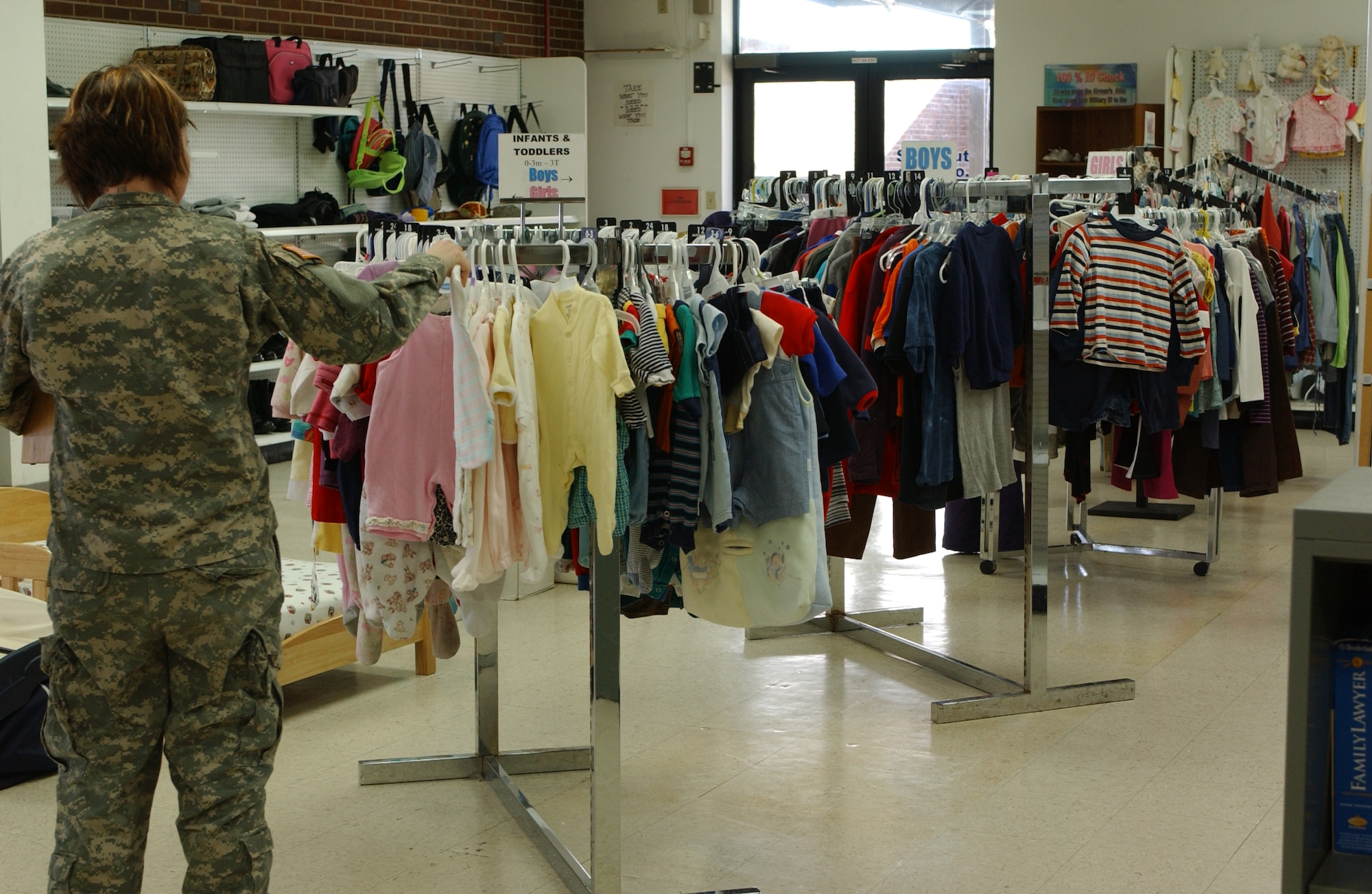 A Soldier browses the selection at Peterson AFB's Airman's Attic located in the former base exchange building near the base chapel. The Attic is open to all servicemembers E-5 and below and offers a broad assortment of items free of charge for personal use. Like all helping organizations this time of year, the Airman’s Attic needs donations of quality items. (Courtesy photo)