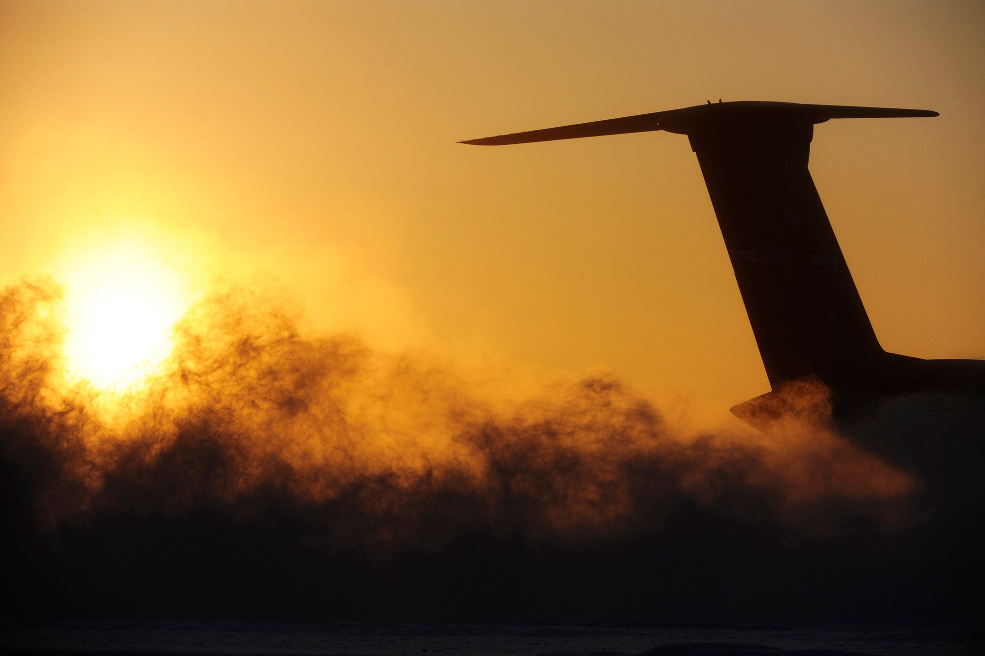 A C-5M Super Galaxy drives through the deep snow on the flightline while conducting cold weather testing Dec. 12 at Eielson Air Force Base, Alaska. This is the first C-5M with new CF-6 engines, pylons and auxiliary power units, with upgrades to the aircraft's skin and frame, flight controls, landing gear and the pressurization system that went through cold-weather testing. The aircraft sat for more than 24 hours in temperatures low as minus 25 degrees. (U.S. Air Force photo/Senior Airman Jonathan Snyder) 
