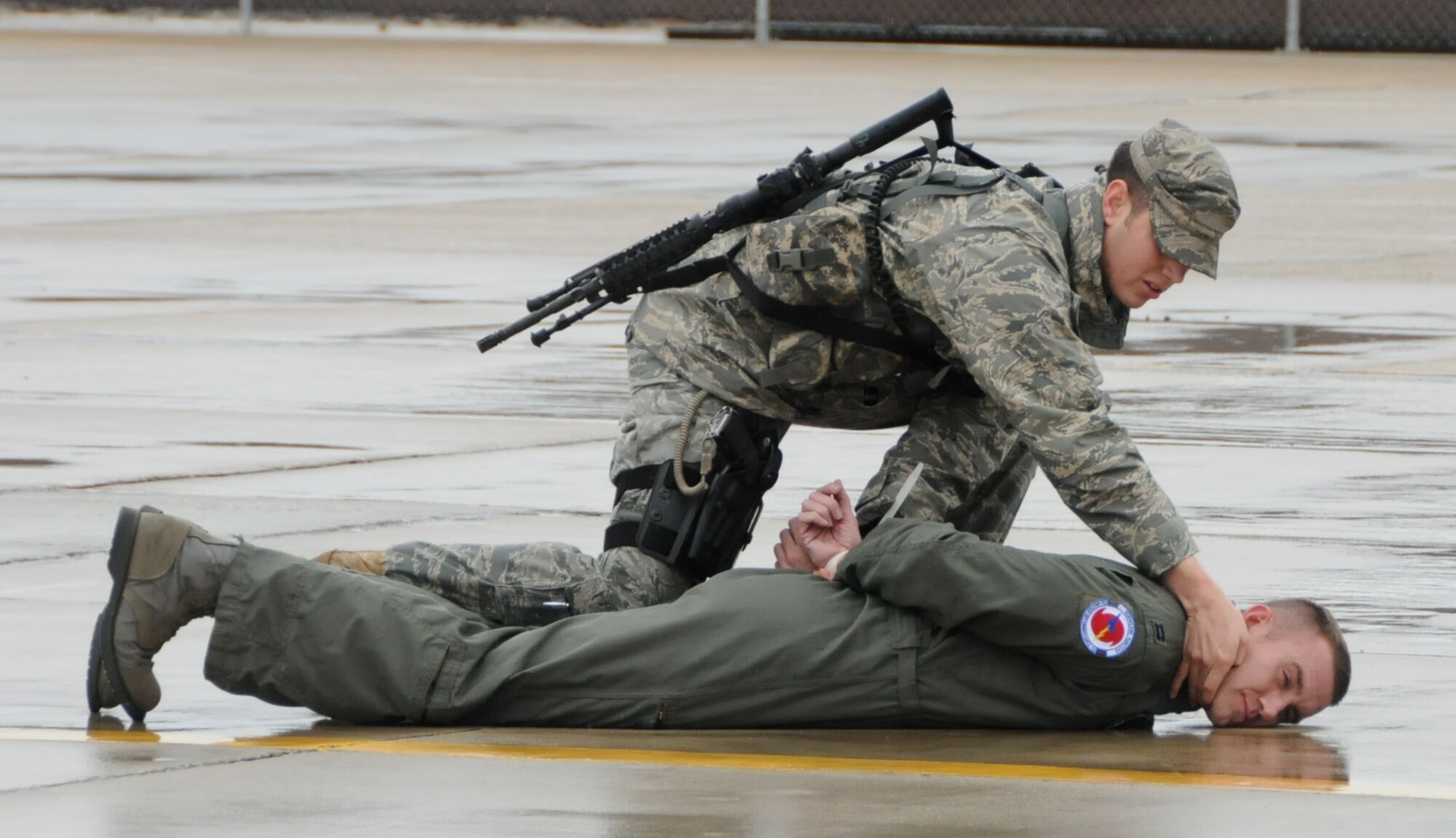 Senior Airman Christopher Turk-nett, 81st Security Forces Squadron, searches Tech. Sgt. Daniel Wilburn, an instructor from the 338th Training Squadron, who portrayed the hijacker in the exercise scenario.
(U.S. Air Force photo by Kemberly Groue)
