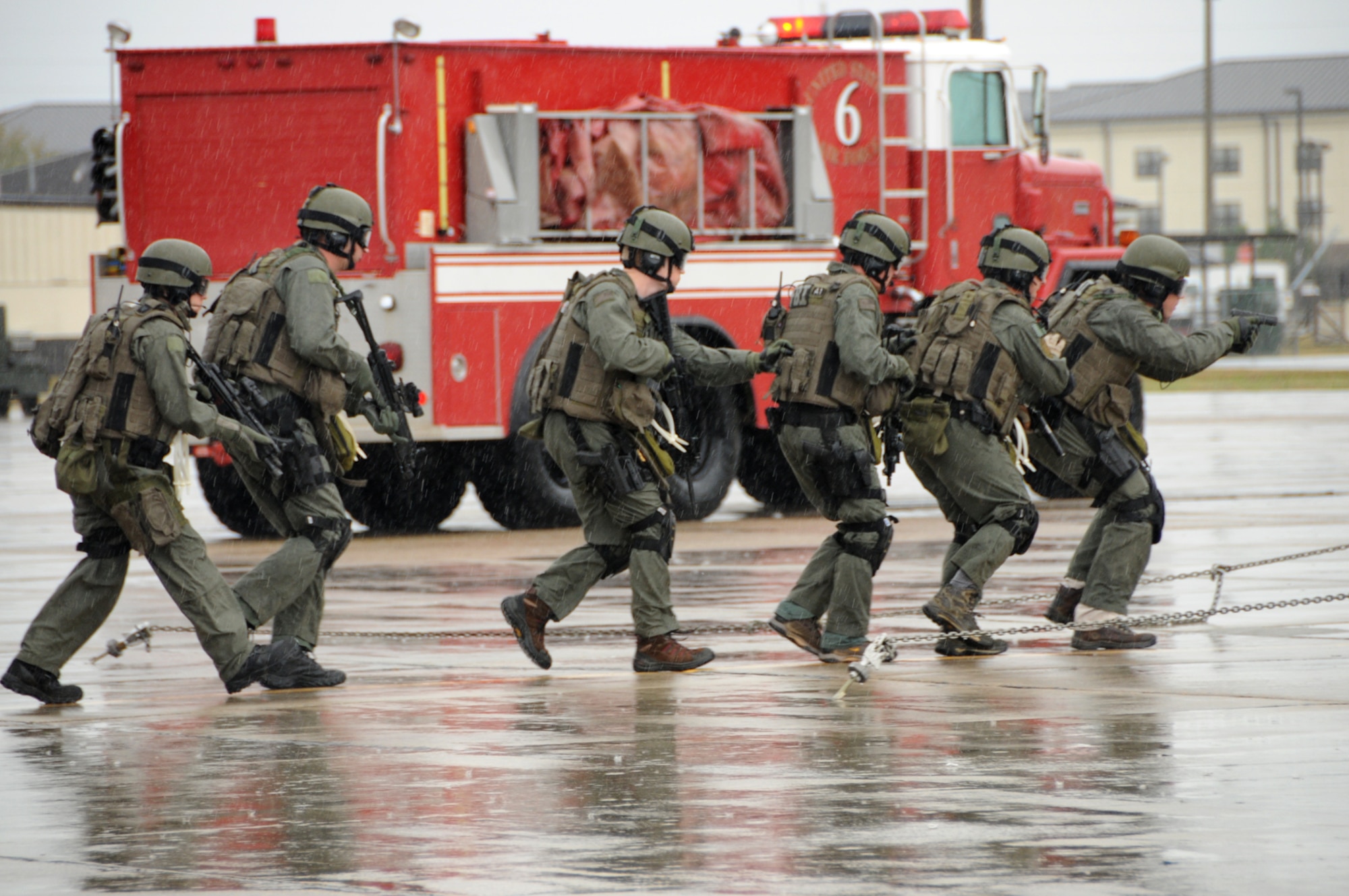 An FBI special weapons and tactics team moves in to surround a C-130 during an exercise on the flightline Dec. 12.  (U.S. Air Force photo by Kemberly Groue)