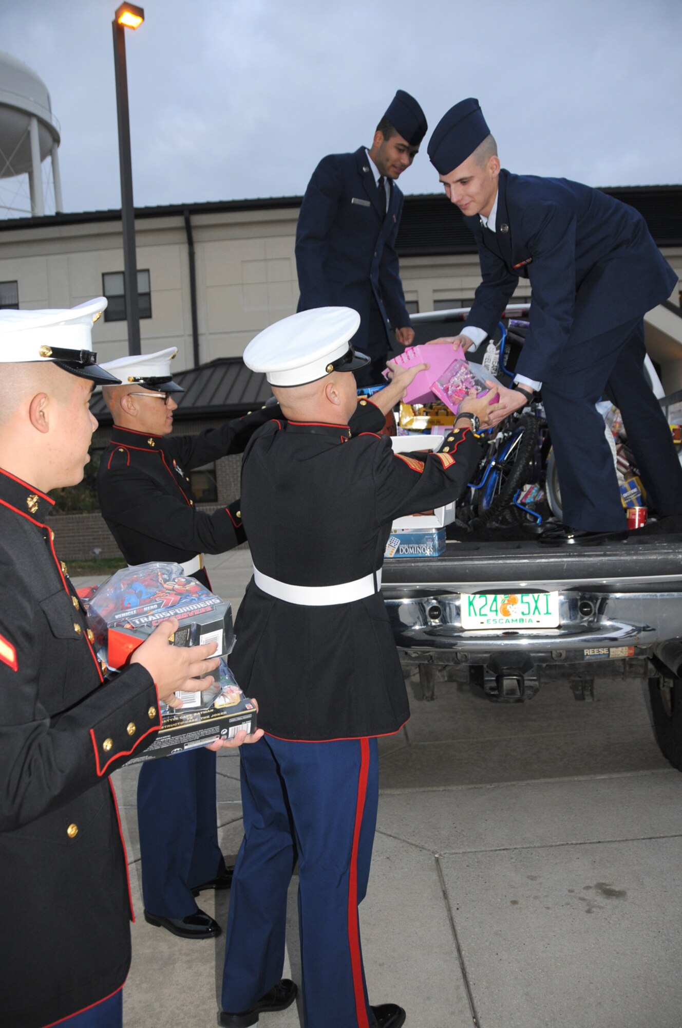 From left, Pvt. 1st Class Lukah Chang, Pvt. Adam Naegeli and Staff Sgt. Troy Johnson from Keesler’s Marine Corps Detachment  pass Toys for Tots donations to Airmen Basic Jordan Hines and Matthew King, members of the 336th Training Squad-ron.  The 336th TRS held a drive to collect the toys for the Marine Corps’ annual nationwide campaign. (U.S. Air Force photo by Kemberly Groue)