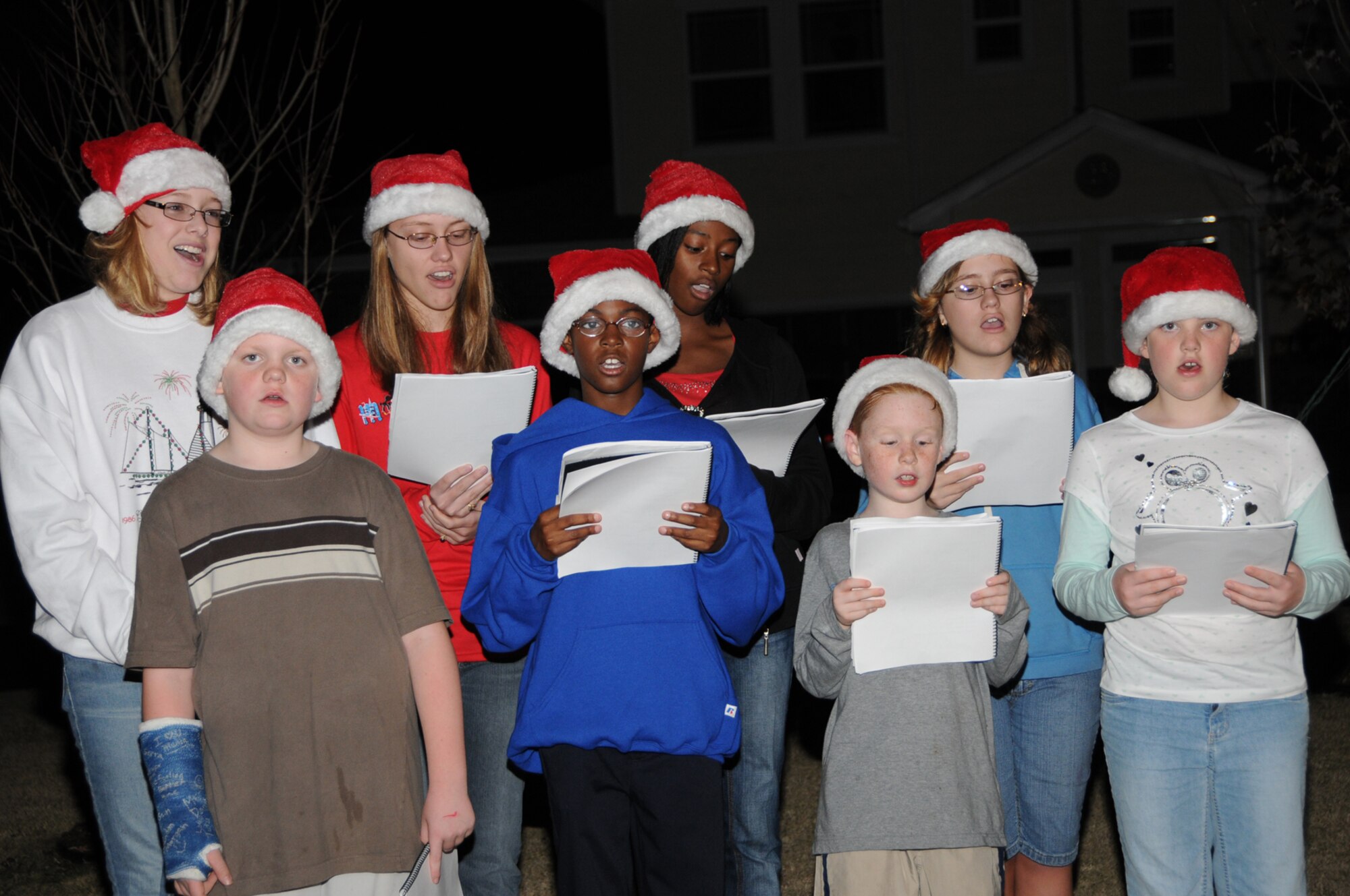 A group of children gathered together in the Bay Ridge housing area Monday to sing Christmas carols.  (U.S. Air Force photo by Kemberly Groue)