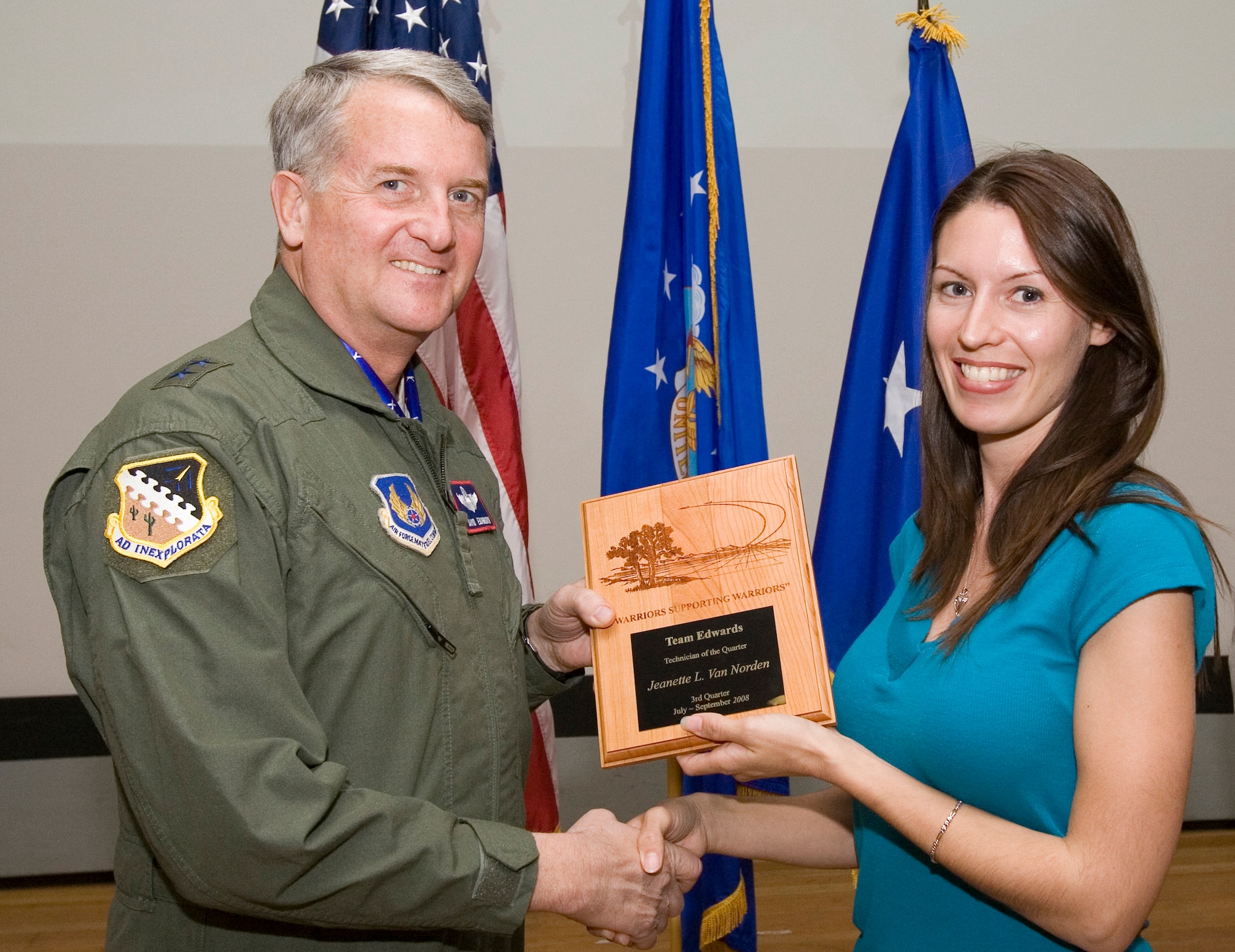 Jeanette Van Norden, 95th Aerospace Medicine Squadron environmental health technician, receives the Technician Civilian of the 3rd Quarter award from Maj. Gen. David Eichhorn, Air Force Flight Test Center commander, during an award ceremony at the base theater Dec. 12. (Air Force photo by Jet Fabara)