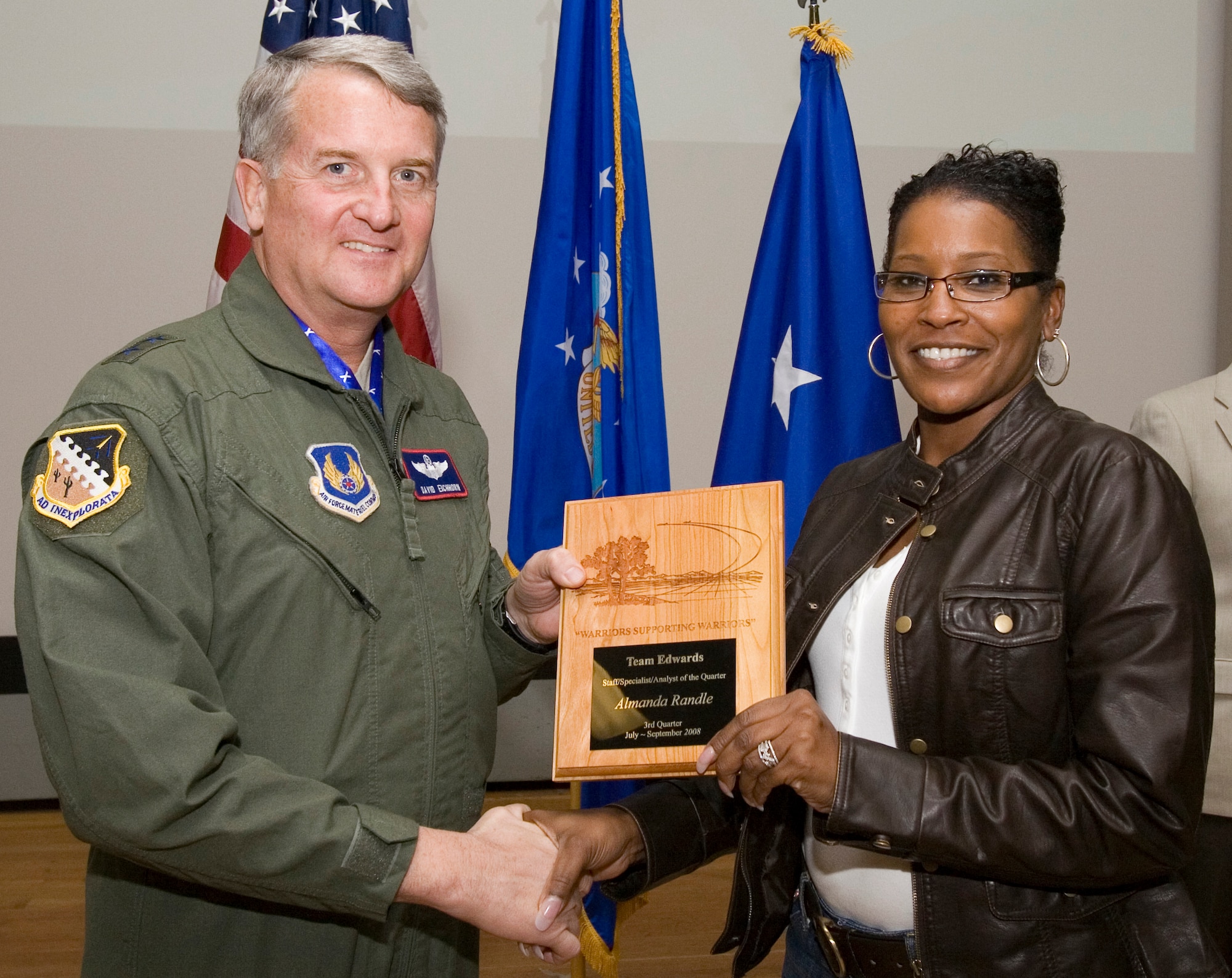Almanda Randle, 95th Medical Support Squadron budget analyst, receives the   Staff, Specialist and Analyst Civilian of the 3rd Quarter award from Maj. Gen. David Eichhorn, Air Force Flight Test Center commander, during an award ceremony at the base theater Dec. 12. (Air Force photo by Jet Fabara)