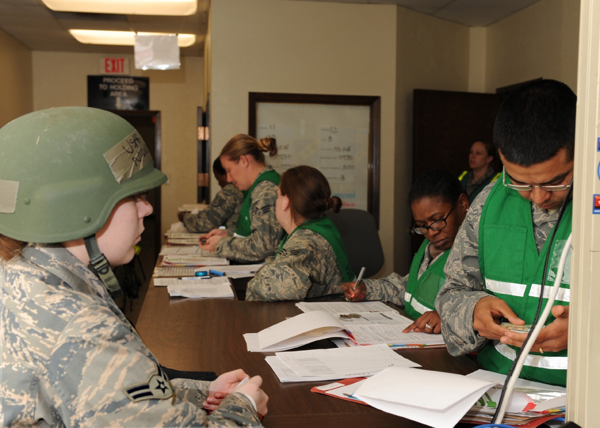 DYESS AIR FORCE BASE, Texas -- An Airman has her identification card checked as she processes through the deployment line during an operational readiness exercise here, Dec 15. This exercise was performed to prepare Airmen for the operational readiness inspection coming up this January. (U.S. Air Force photo/Senior Airman Jennifer Romig)