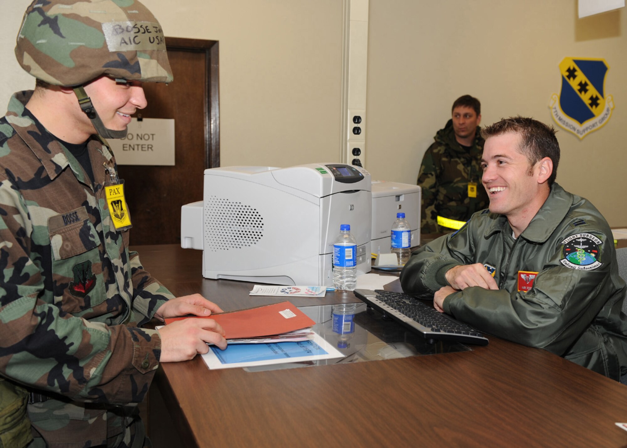 DYESS AIR FORCE BASE, Texas -- Airman First Class Jonathan Bosse, from the 7th Force Support Squadron, has his medical records inspected by Captain Mark Rogers, from the 7th Areomedical Dental Squadron, while on the deployment processing line during the operational readiness exercise here, Dec. 15. All Airmen tasked to deploy during an exercise must have all their records up to date and ready as if deploying for a real world mission. (U.S. Air Force photo/Senior Airman Jennifer Romig)