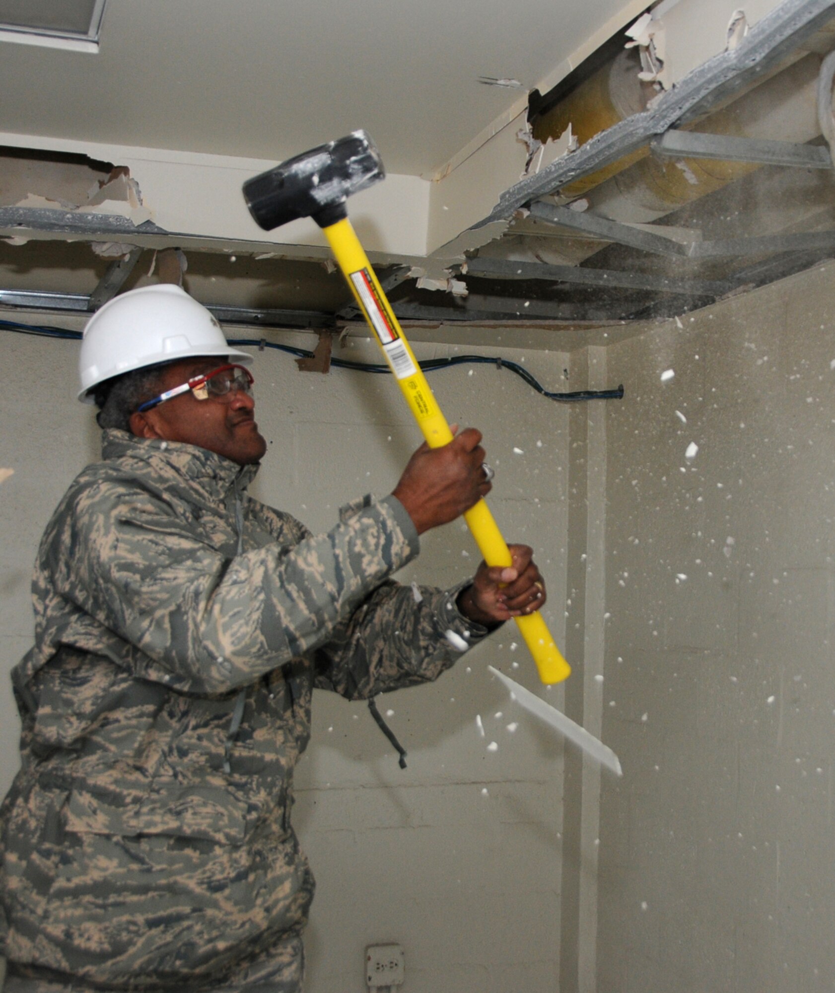 Maj. Gen. Al Flowers, 2nd Air Force commander, uses a sledge hammer to begin demolition of Avery Manor, one of the old dormitories in the Triangle, Dec. 12.  There are no plans to redevelop the area since it’s in the airfield clear zone, according to 1st Lt. Justin Delorit, 81st Civil Engineer Squadron.  Also, the lieutenant mentioned an initiative for bases to reduce their physical footprint by 20 percent by removing old buildings that are no longer needed.