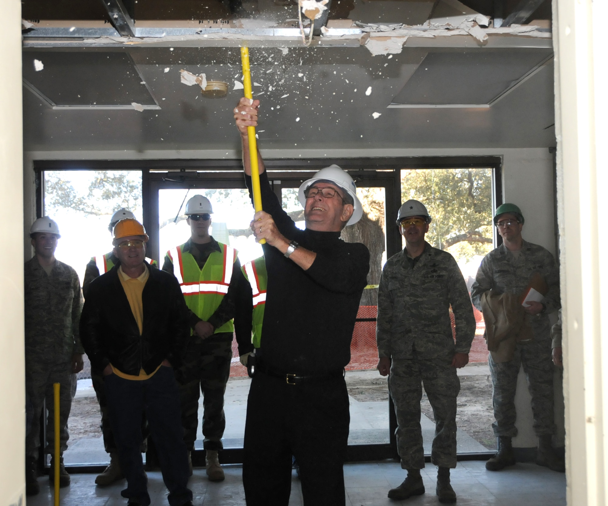 J.J. Vollmuth, Chief Master Sgt (Ret), uses a sledge hammer to begin demolition of Avery Manor, one of the old dormitories in the Triangle, Dec. 12.  There are no plans to redevelop the area since it’s in the airfield clear zone, according to 1st Lt. Justin Delorit, 81st Civil Engineer Squadron.  Also, the lieutenant mentioned an initiative for bases to reduce their physical footprint by 20 percent by removing old buildings that are no longer needed.