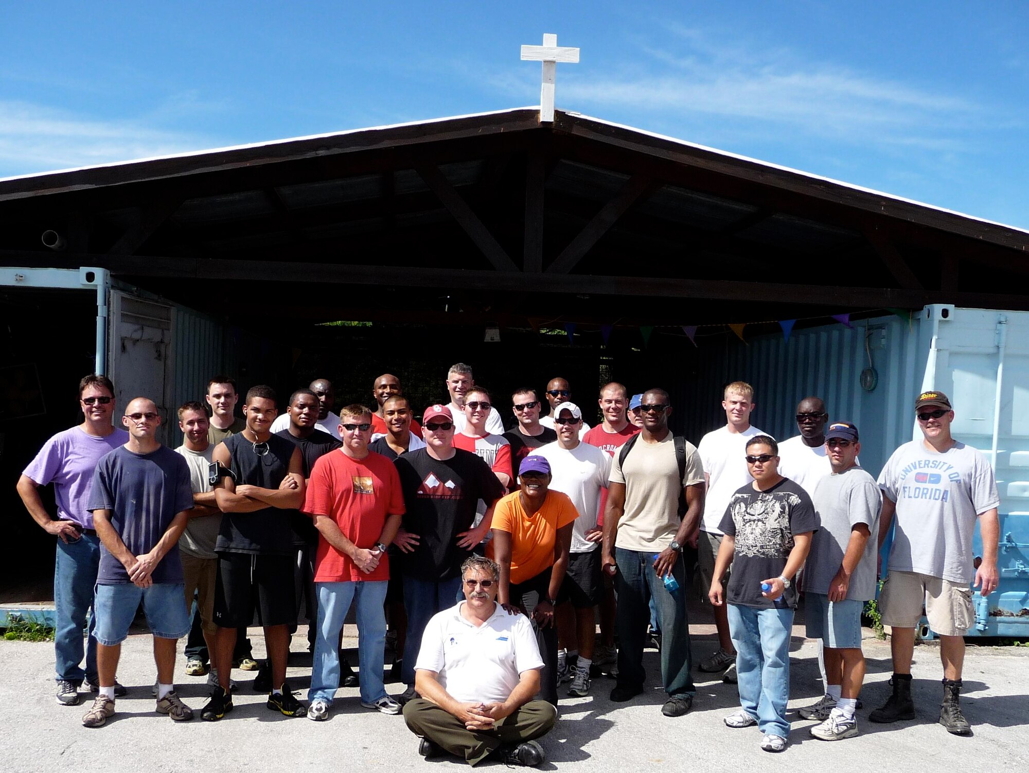 Members of the 429th Expeditionary Operations Squadron pose with Brother Herman (seated) at the Siloam Children's Hospice in Curacao, Netherlands Antilles.  The team completed a series of volunteer projects at the home for orphaned, abandoned and terminally ill children during their deployments to the island.  (Photo by Capt Nathan Broshear)