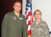 Second Lt.  Grant Georgulis, an air battle manager from Tinker AFB, Okla., administers the Oath of Enlistment to his mother, Master Sgt.  Jodi Georgulis, 919th Maintenance Operations Flight information management NCOIC, Dec. 6 in the wing conference room.  Reenlisting during the December unit training assembly, Sergeant Georgulis was joined by another son who is a reservist at Duke Field, Senior Airman Zachery Perritt, 919th Maintenance Squadron crew chief, and her husband, retired Master Sgt.  Mark Georgulis. (U.S. Air Force photo/ Senior Airman Jon McCallum)