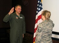Second Lt.  Grant Georgulis, an air battle manager from Tinker AFB, Okla., administers the Oath of Enlistment to his mother, Master Sgt.  Jodi Georgulis, 919th Maintenance Operations Flight information management NCOIC, Dec. 6 in the wing conference room.  Reenlisting during the December unit training assembly, Sergeant Georgulis was joined by another son who is a reservist at Duke Field, Senior Airman Zachery Perritt, 919th Maintenance Squadron crew chief, and her husband, retired Master Sgt.  Mark Georgulis. (U.S. Air Force photo/ Senior Airman Jon McCallum)