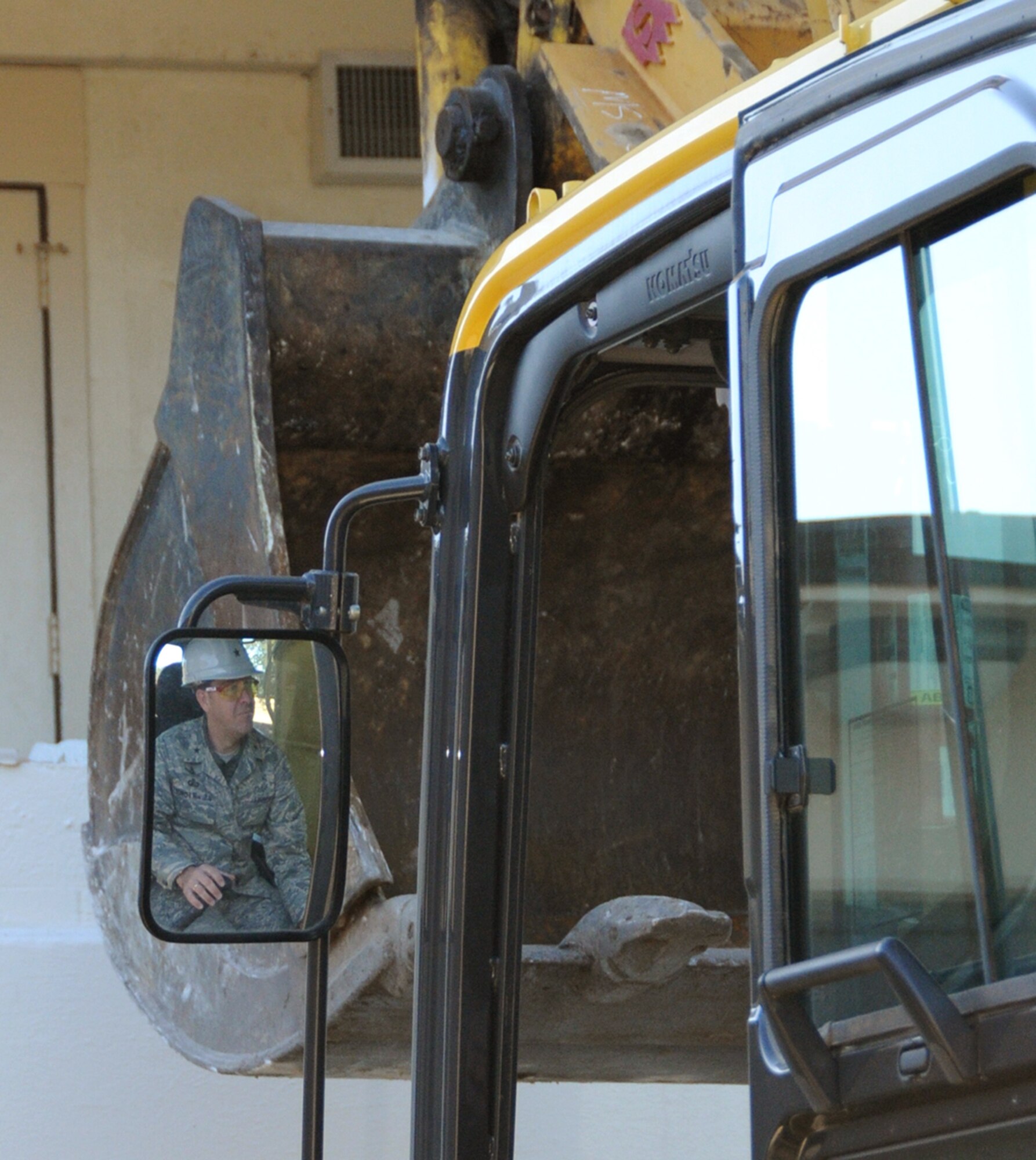Brig. Gen. Greg Touhill, 81st Training Wing commander, uses an excavator to begin demolition of Avery Manor, one of the old dormitories in the Triangle, Dec. 12.  There are no plans to redevelop the area since it’s in the airfield clear zone, according to 1st Lt. Justin Delorit, 81st Civil Engineer Squadron.  Also, the lieutenant mentioned an initiative for bases to reduce their physical footprint by 20 percent by removing old buildings that are no longer needed.  (U.S. Air Force photo by Kemberly Groue)