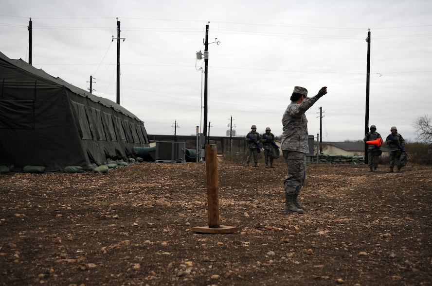 Airmen Basic trainees in body armor walk through an unexploded ordnance disposal training lesson taught by Tech. Sgt. Nicole Pino during the five-day deployment exercise called the Basic Expeditionary Airman Skills and Training, or BEAST, which kicked off Dec. 15 at Lackland Air Force Base, Texas. Sergeant Pino is a military training instructor for the 737th Training Support Squadron. The BEAST is the newly built complex added into the extended, 8.5-week Basic Military Training curriculum that began Nov. 5. (U.S. Air Force photo/Staff Sgt. Desiree N. Palacios) 