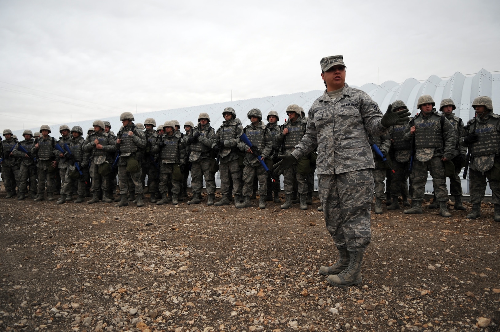 Airmen Basic trainees in body armor wait their turn to go through an unexploded ordnance disposal training lesson taught by Tech. Sgt. Nicole Pino during the five-day deployment exercise called the Basic Expeditionary Airman Skills and Training, or BEAST, which kicked off Dec. 15 at Lackland Air Force Base, Texas. Sergeant Pino is a military training instructor for the 737th Training Support Squadron. The BEAST is the newly built complex added into the extended, 8.5-week Basic Military Training curriculum that began Nov. 5. (U.S. Air Force photo/Staff Sgt. Desiree N. Palacios) 