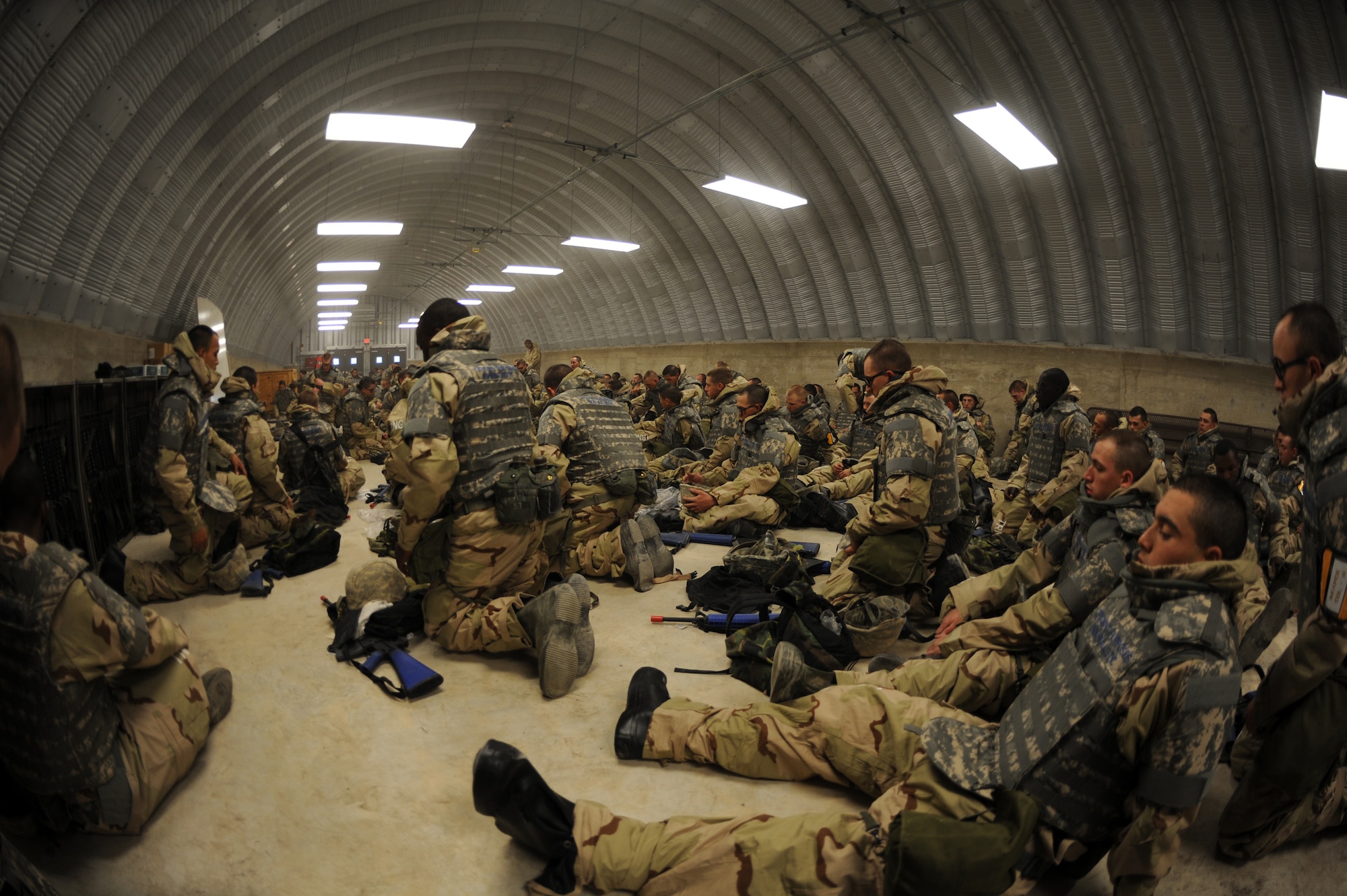 Airmen Basic trainees take a break inside a hard shelter after inspecting each others body armor during the five-day deployment exercise called the Basic Expeditionary Airman Skills and Training, or BEAST, which kicked off Dec. 15 at Lackland Air Force Base, Texas. The BEAST is the newly built complex added into the extended, 8.5-week Basic Military Training curriculum that began Nov. 5. (U.S. Air Force photo/Staff Sgt. Desiree N. Palacios) 