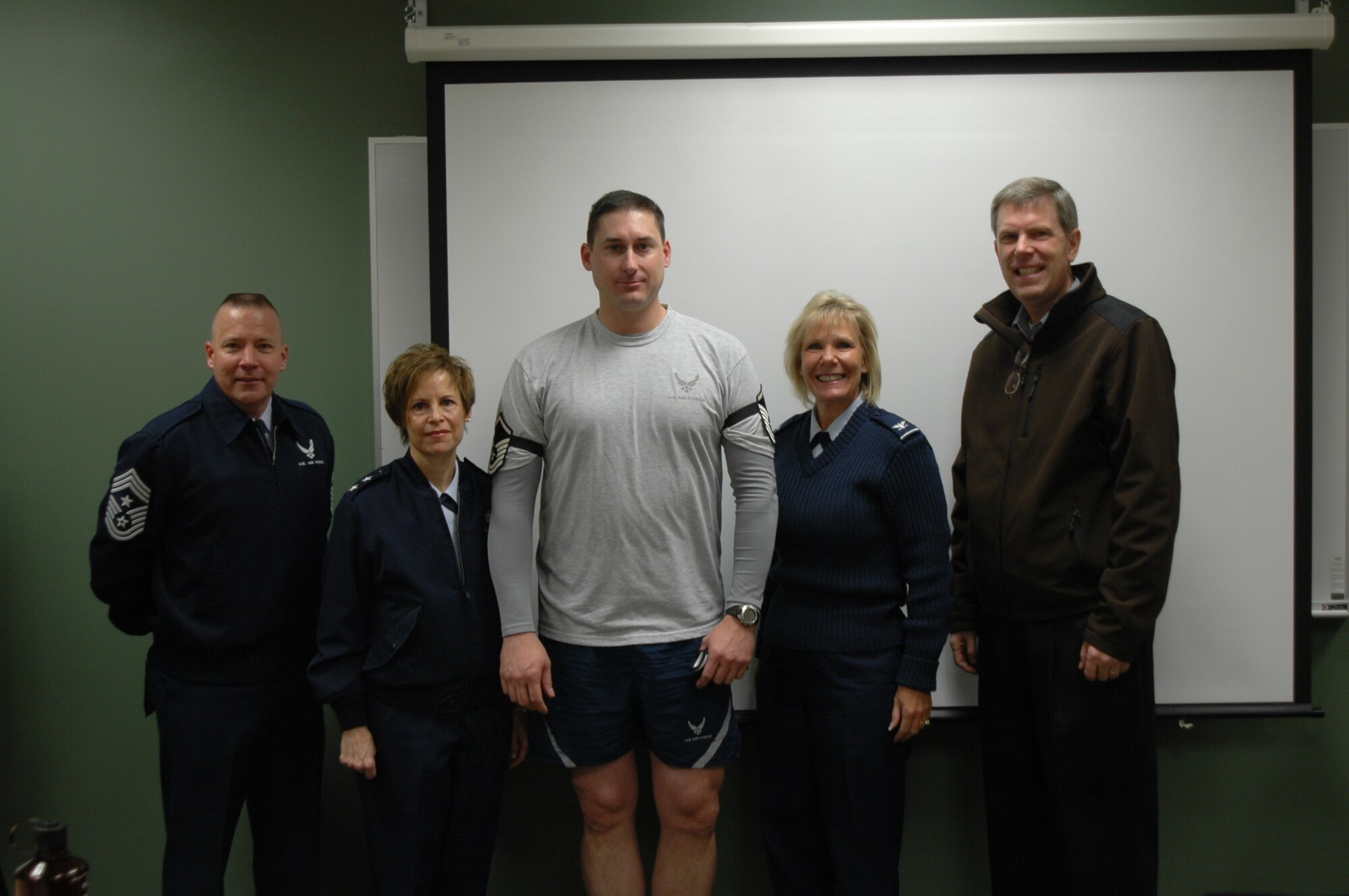 Master Sgt. Brian Schilhabel, a member of Team Hill's Explosive Ordnance Disposal Flight, stands in the middle with Chief Master Sgt. Kevin Candler, Ogden Air Logistics Center and 75th Air Base Wing Command Chief; Maj. Gen Kathleen Close, OO-ALC Commander; Col. Linda Medler, 75th Air Base Wing Commander and Mr. Mark Johnson, OO-ALC Executive Director immediately following his promotion from General Close under the Stripes for Exceptional Performer program.  The STEP program is designed to recognize exceptional performers for promotion to the grades of staff sergeant through master sergeant. The Ogden Air Logistics Center only received one stripe for an Airman to be STEP promoted this year. The STEP program allows the center commander to conduct on-the-spot promotions for exceptional Airmen. Under the standard Weighted Airmen Promotion System, promotees are measured against all other eligible individuals and if selected, can wait up to 12 months before they officially wear the rank. With the STEP program, the selected assume the new rank immediately.