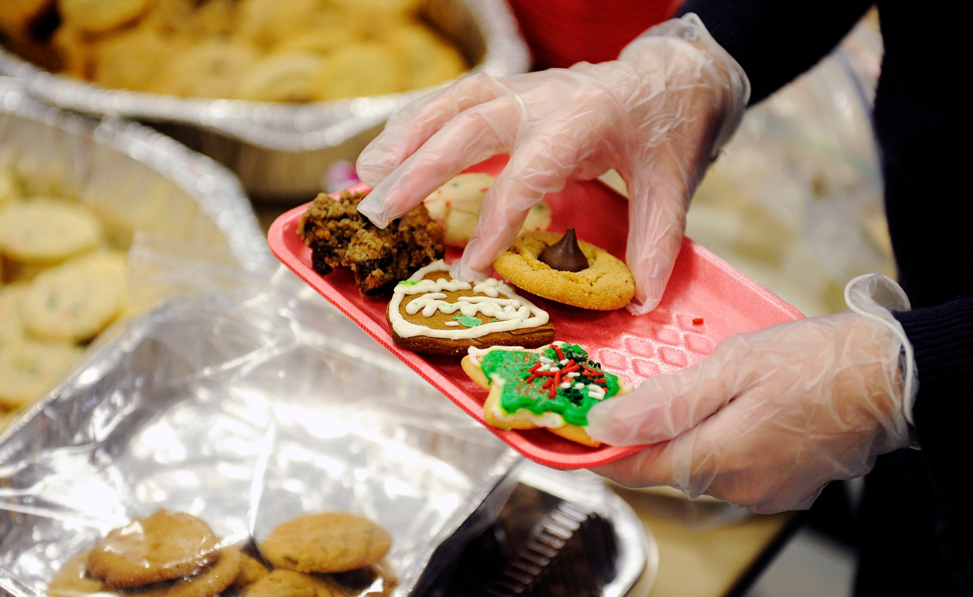 MOUNTAIN HOME AIR FORCE BASE, Idaho -- Spouses and volunteers from the base arrange an assortment of cookies along with homemade Christmas cards to be sent to deployed Airmen from Mountain Home AFB and Airmen in the dorms Dec. 8. The cookie drive, headed by Alison Browne and M.J. Maxwell, raised more than 1,600 dozen cookies for Airmen spending time away from their families. (U.S. Air Force photo/ Airman 1st Class Ryan Crane)