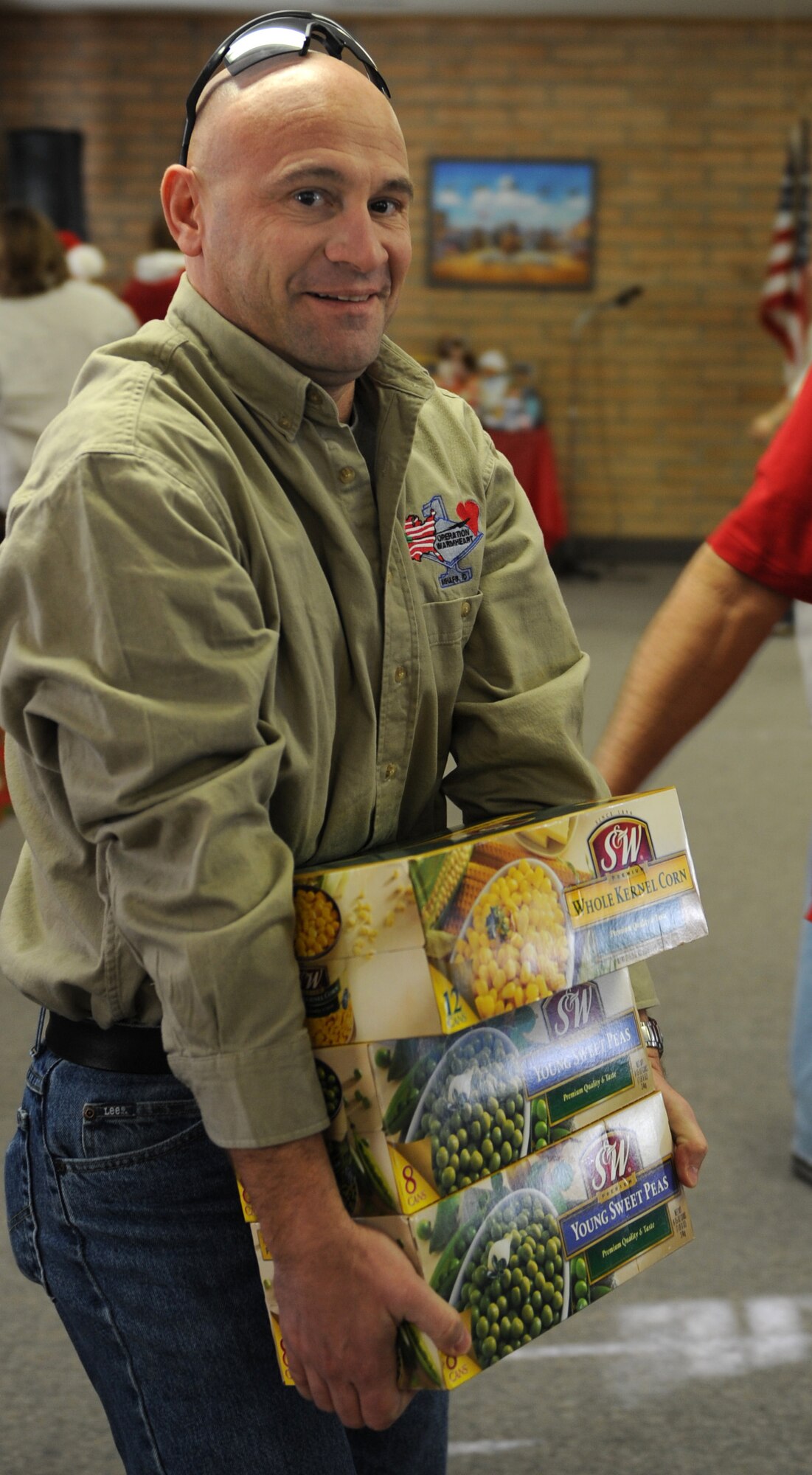MOUNTAIN HOME AIR FORCE BASE, Idaho -- Master Sgt. Christopher Attrill, 366th Communications Squadron first sergeant, carries donations for Operation Warmheart after a ceremony honoring the program in the Silvercrest community of Nampa, Idaho, Dec. 6. The ceremony served as a way for the residents of Silvercrest to show their appreciation for Operation Warmheart, a non-profit organization that provides temporary assistance to military personnel and certain individuals and agencies from the local community. (U.S. Air Force photo/Airman Debbie Lockhart)