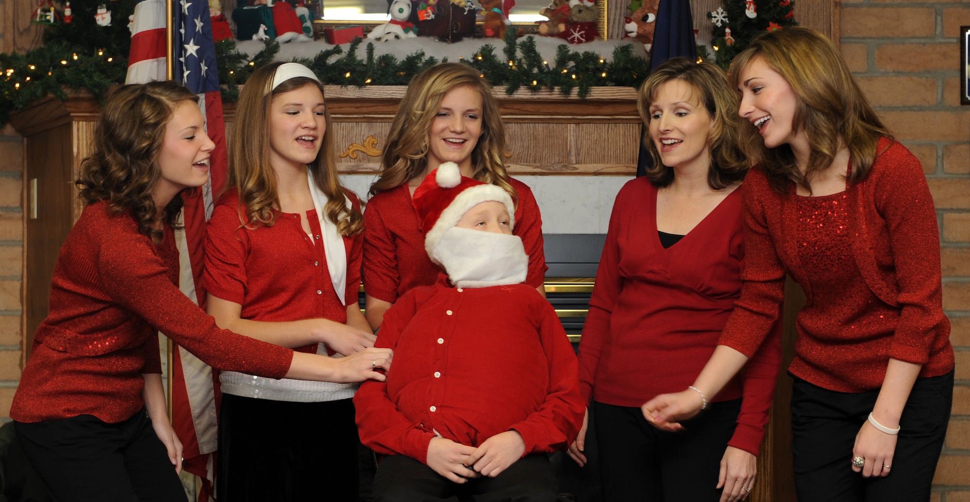 MOUNTAIN HOME AIR FORCE BASE, Idaho - The Kofeod family sings Christmas songs during a ceremony honoring the first sergeants of Operation Warmheart in the Silvercrest community of Nampa, Idaho, Dec. 6. The ceremony served as a way for the residents of Silvercrest to show their appreciation for Operation Warmheart, a non-profit organization providing temporary assistance to military personnel and certain individuals and agencies from the local community. (U.S. Air Force photo/Airman Debbie Lockhart)