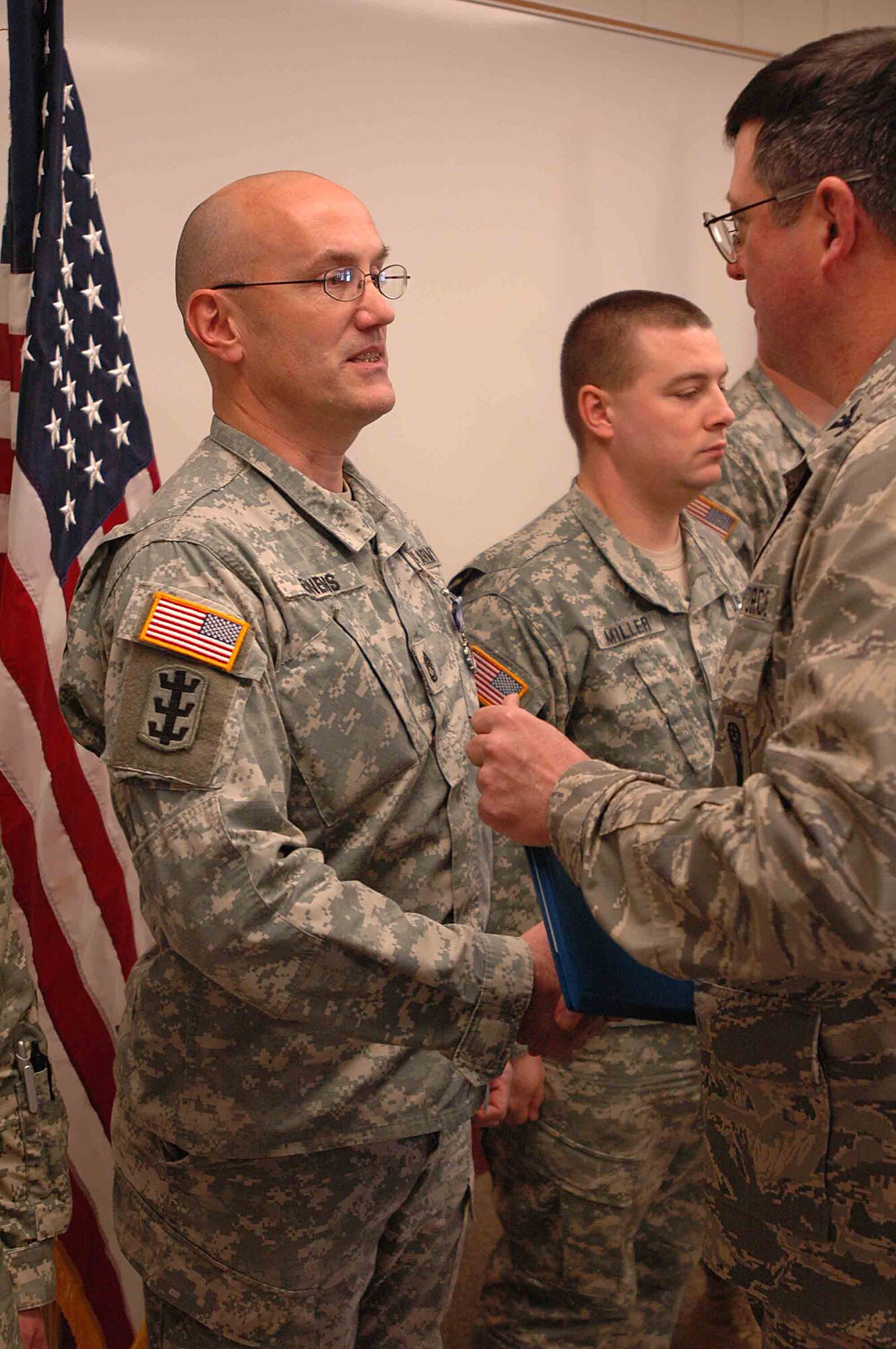 BISMARCK, N.D. -- Civil Support Team Awarded-002: Sgt. 1st Class Michael Jennens receives the Air Force Achievement Medal from Col. Lyman Faith, Minot Air Force Base's 91st Maintenance Group commander. Jennens and four other Soldiers from the North Dakota National Guard's 81st Civil Support Team received the medals at the team's headquarters at Fraine Barracks, Bismarck, Dec. 15. (courtesy photo)