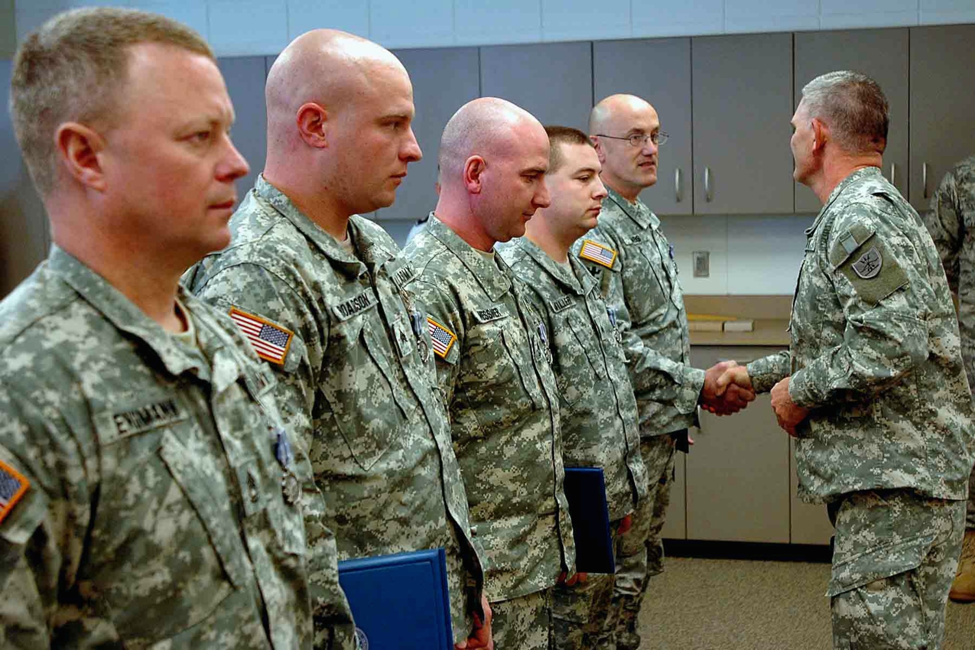 BISMARCK, N.D. -- Maj. Gen. David A. Sprynczynatyk, North Dakota National Guard adjutant general, congratulates, from right to left, Sgt. 1st Class Michael Jennens, Sgt. William Miller, Sgt. 1st Class Brian Messmer, Sgt. Jamie Roaldson and Sgt. 1st Class Phil Engmann after the 81st Civil Support Team (CST) Soldiers were awarded the Air Force Achievement Medal at the CST headquarters at Fraine Barracks, Bismarck, Dec. 15. The medals were awarded for supporting the 91st Missile Wing, Minot Air Force Base, during a recovery response near Makoti, N.D., August 2008. (courtesy photo)