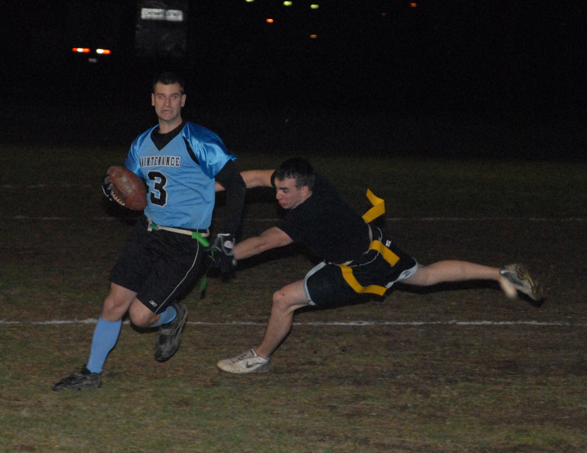 Daniel Archer, 436th Civil Engineer Squadron defensive end, sacks James Goerss, 436th Maintenance Squadron quarterback, during the Intramural Flag Football Championship game Dec. 15.  MXS defeated CES 19-0.