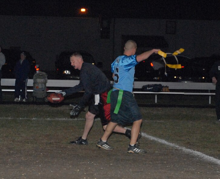 Micah Wilson, 436th Maintenance Squadron linebacker, tackles Patrick Osborn, 436th Civil Engineer Squadron receiver, during the Intramural Flag Football Championship game Dec. 15.  MXS defeated CES 19-0.