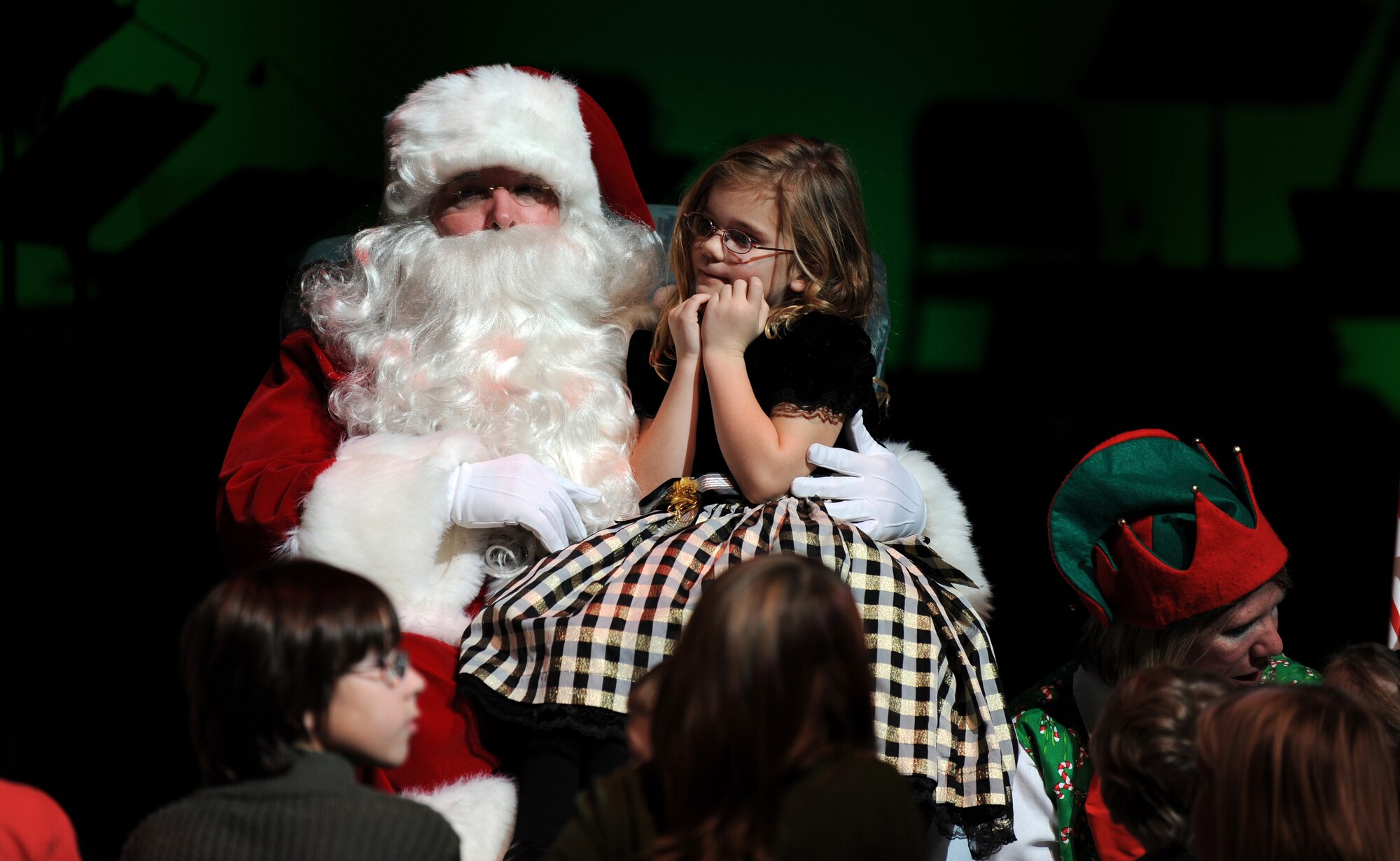 OFFUTT AIR FORCE BASE, Neb. -- Six-year-old Jaeli Cole, from Omaha Neb., had the best seat in the house when she got to sit with Santa on the Holland Perfroming Arts Center stage. Mrs. Clause read the children the story "Why Christmas Trees Aren't Perfect," Dec. 12 as part of the 22nd annual Heartland of America Band's hoiday concert.  The band performed to a full capacity audience of roughly 2,000 metro area residents as part of a four day concert series.

U.S. Air Force Photo by Josh Plueger