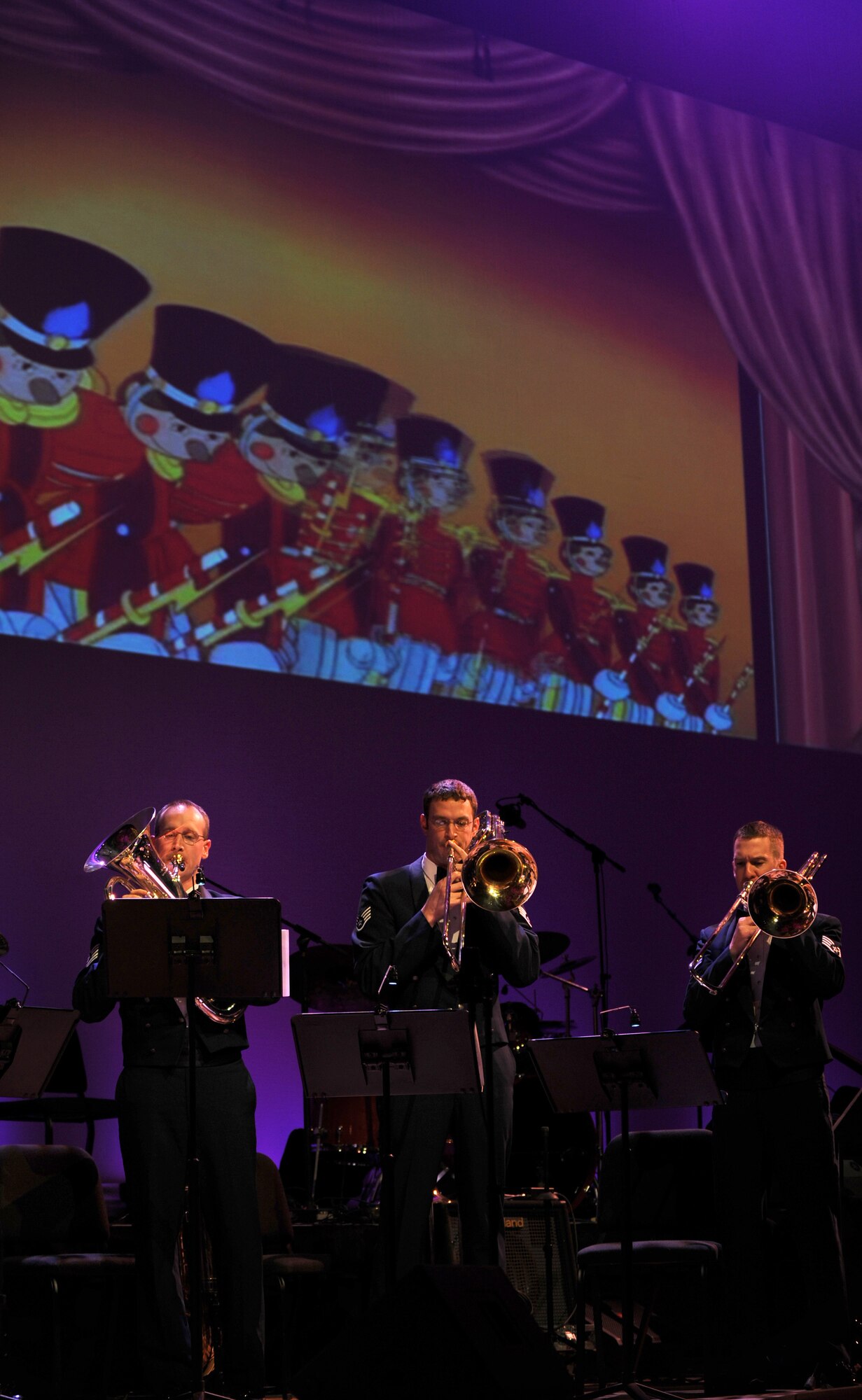 OFFUTT AIR FORCE BASE, Neb. -- The Heartland of America Band's Brass in Blue ensemble perfrom "March of the Toys" as the cartoon Babes in Toyland plays on the big screen behind them, Dec. 12 at the Holland Performing Arts Center.  The performance was part of the band's annual Holiday concert series. 
U.S. Air Force Photo by Josh Plueger