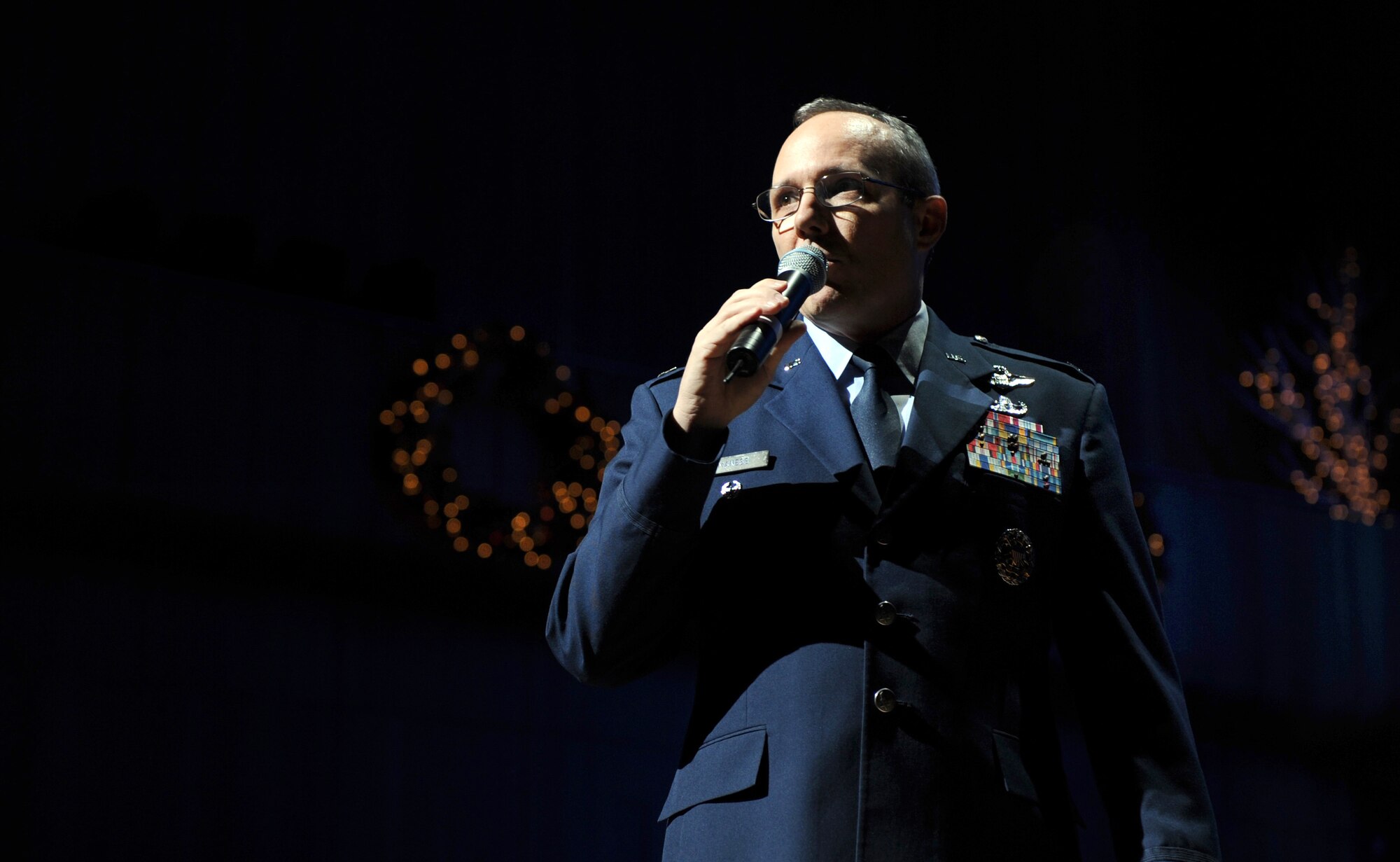 OFFUTT AIR FORCE BASE, Neb. -- Col. Robert L. Maness,  55th Wing vice commander, presents the band to concert goers before the annual Heartland of America Band's holiday concert at the Holland Performing Arts Center, Dec. 12.

U.S. Air Force Photo by Josh Plueger