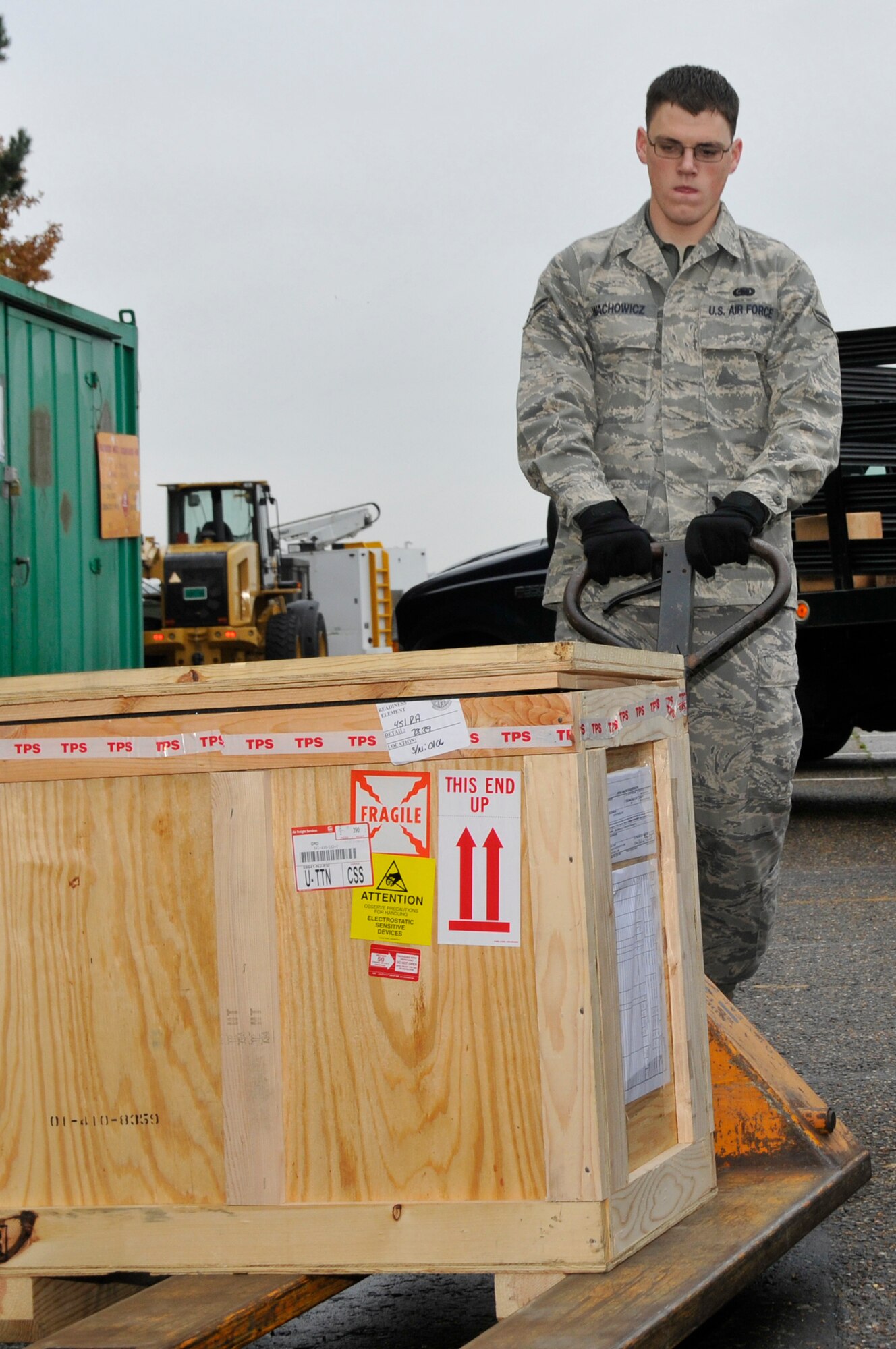 Airman 1st Class Andrew Wachowicz, 48th Logistics Readiness Squadron flight service center technician, moves a broken part to a truck using a pallet jack, Nov. 14 at RAF Lakenheath, England. The flight service center verifies and process’s over $44 million in assets a month. (U.S. Air Force photo by Airman 1st Class Perry Aston)