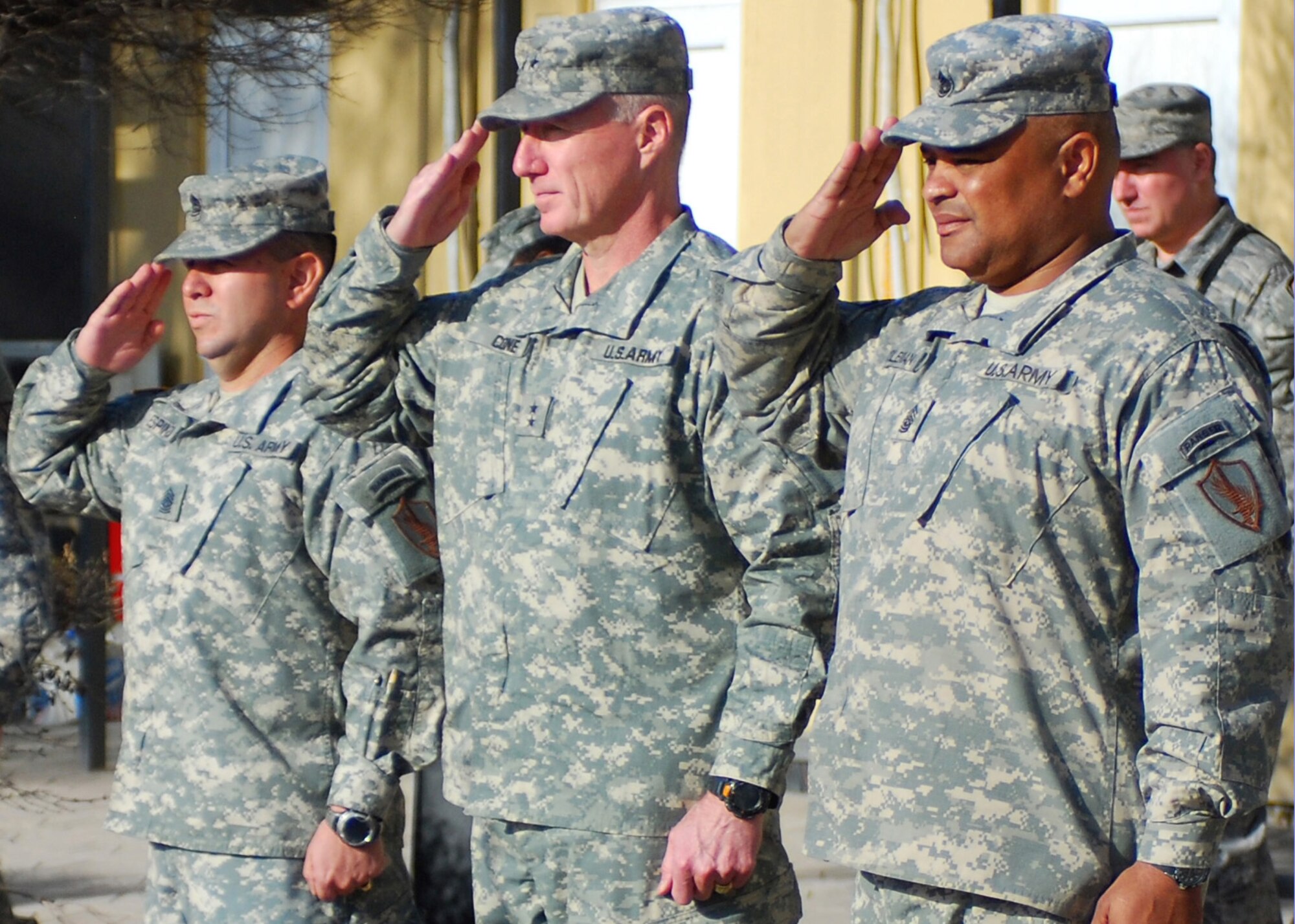 Sgt. Maj. Ruben Espinoza (left), Maj. Gen. Robert Cone (center), Combined Security Transition Command – Afghanistan commanding general, and Command Sgt. Maj. Arthur L. Coleman Jr. (right) salute the colors during a command sergeant major change of responsibility ceremony at Camp Eggers.  ((Photo by Mass Communication Specialist Seaman Tim Newborn, USN) (Released)