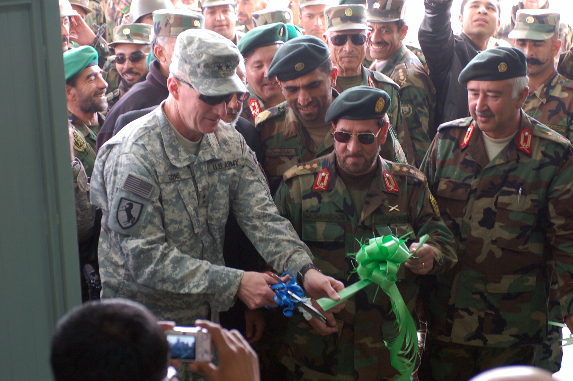 Maj. Gen. Robert Cone, Combined Security Transition Command-Afghanistan commanding general, cuts a ribbon at Kabul Military Training Center. The ceremony marked the establishment of a new ANA NCO academy. (Photo by Air Force Staff Sgt. Robert R. Wollenberg Jr.) (Released) 