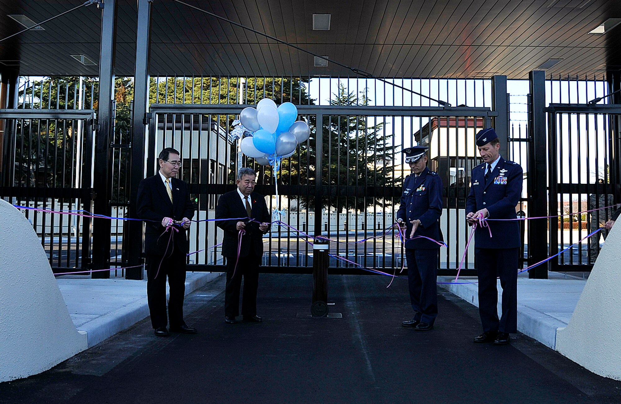 MISAWA AIR BASE, Japan -- Col. David Stilwell, 35th Fighter Wing commander and the CEOs of the two contracting companies, cut the ribbon during the main gate opening ceremony on, Dec. 16, 2008.  The main gate had been closed for nine months while under construction.  (U.S. Air Force photo by Senior Airman Chad Strohmeyer)