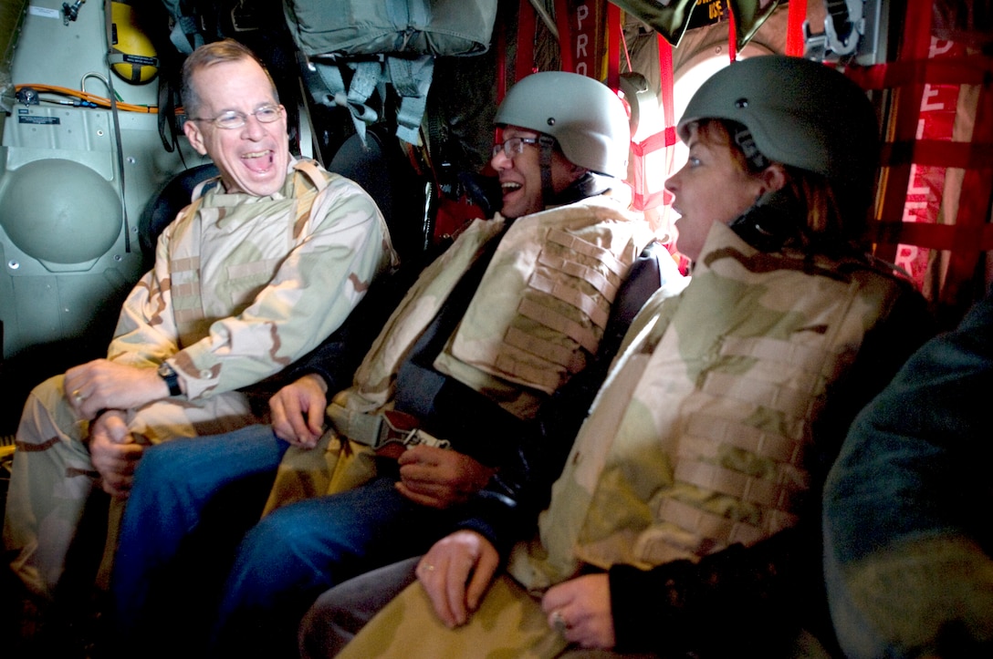 U.S. Navy Adm. Mike Mullen, chairman of the Joint Chiefs of Staff, enjoys a laugh with comedians Lewis Black and Kathleen Madigan, Dec. 17, en route to Kandahar, Afghanistan, during the 2008 USO Holiday Tour. Along with his wife Deborah, Mulllen welcomed comedian John Bowman; actress Tichina Arnold; American Idol contestant and country musician Kellie Pickler and Grammy award-winning musician Kid Rock on the tour bringing music and entertainment to servicemembers and their families stationed overseas.