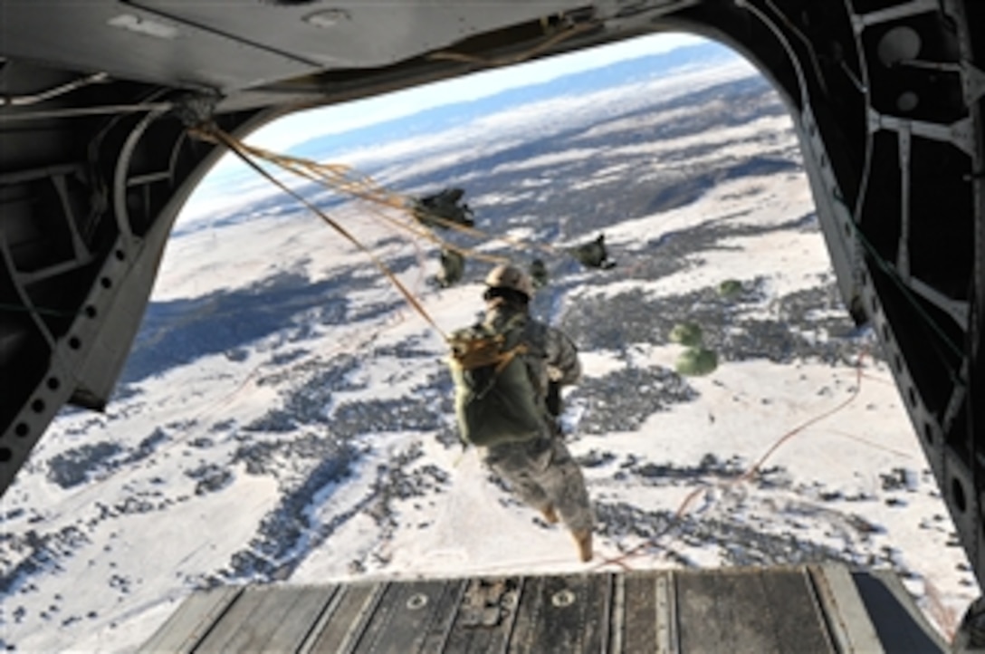 U.S. soldiers assigned to 10th Special Forces Group (Airborne) conduct airborne operations from a CH-47D Chinook aircraft assigned to 2nd Battalion, 135th Aviation Regiment, Colorado Army National Guard over Fort Carson, Colo., on Dec. 10, 2008.  The airborne operation was conducted under the command of Dutch Special Forces with the assistance of a 10th Special Forces Group jumpmaster who helped familiarize the American paratroopers with Dutch commands.  