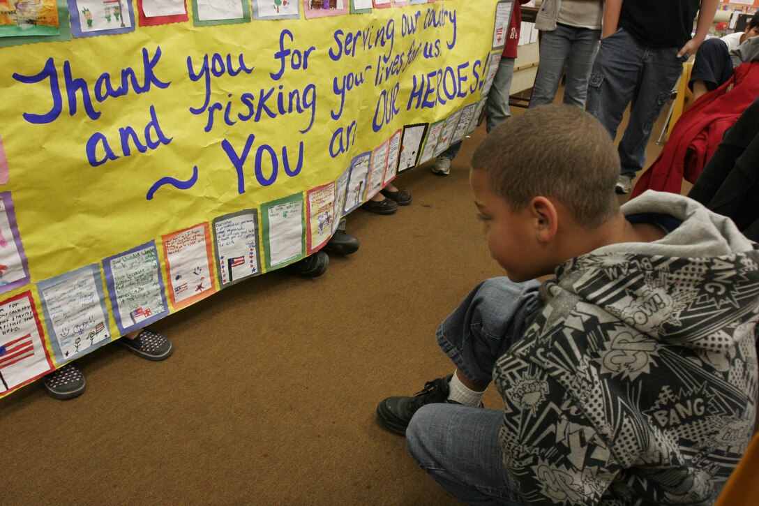 One of the more than 40 students from Santa Margarita Elementary School, Oceanside Unified School District, reads aloud a letter written to the two service members representing Marines and sailors stationed at Wounded Warrior Battalion West on Marine Corps Base Camp Pendleton, Calif.