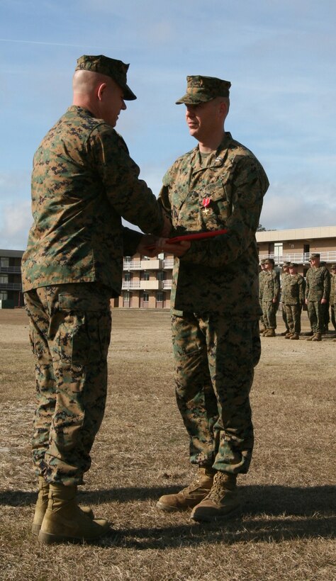 Capt. Christopher Wills, the Kilo Company commander for Battalion Landing Team, 3rd Battalion, 2nd Marine Regiment, 22nd Marine Expeditionary Unit, is congratulated by Brig. Gen. Joseph L. Osterman, Assistant Division Commander for 2nd Marine Division, after Wills received a Bronze Star with combat distinguishing device aboard Camp Lejeune, N.C., Dec. 17, 2008. Wills earned the award for service in Iraq leading a Military Training Team. (Official Marine Corps photo by Staff Sgt. Matt Epright)