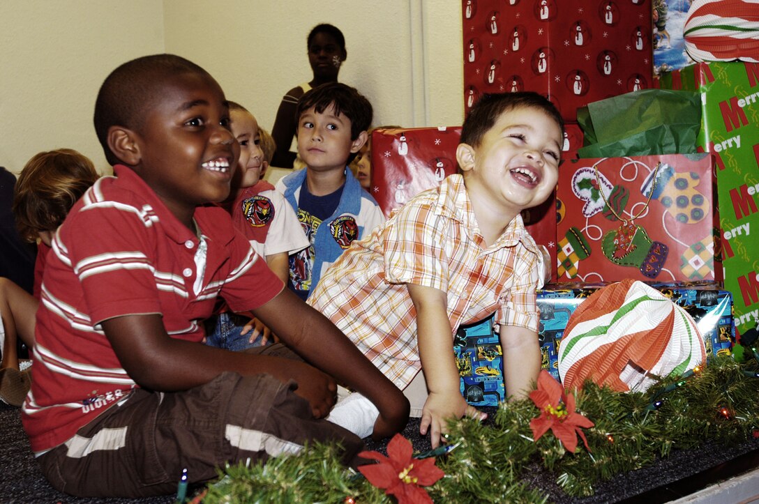 Jonathan Morris, 5, and Diego Lizalde, 3, laugh and play as they await their gifts from Santa Claus at the U.S. Marine Corps Forces, Pacific Headquarters and Service Battalion holiday party at the Pollock Theater Dec. 18. Children enjoyed time with Santa, crafts and face painting.