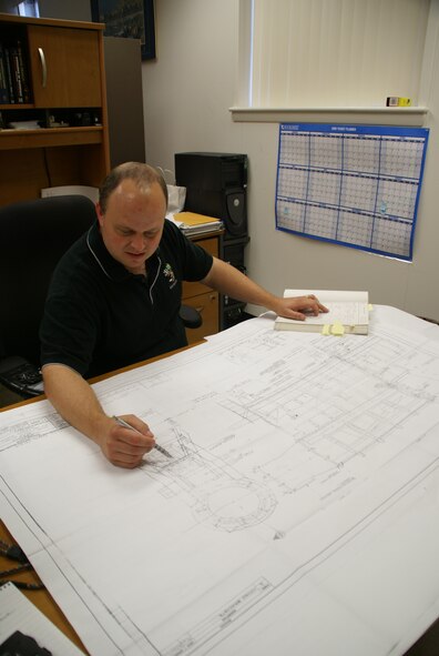 ATA’s Will Vodra studies original hand drawings and calculations of the north leg of one of the test cells at Tunnel 9. The test cell rests on steel v-groove wheels. These wheels allow the nozzle to separate from the test cell and heater for preparations between tests. Vodra was trying to understand the original estimated supporting wheel loads in preparation for an upcoming test while replacing a broken wheel to determine if the calculations underrated the real test cell weight. (Photo by Philip Lorenz III)