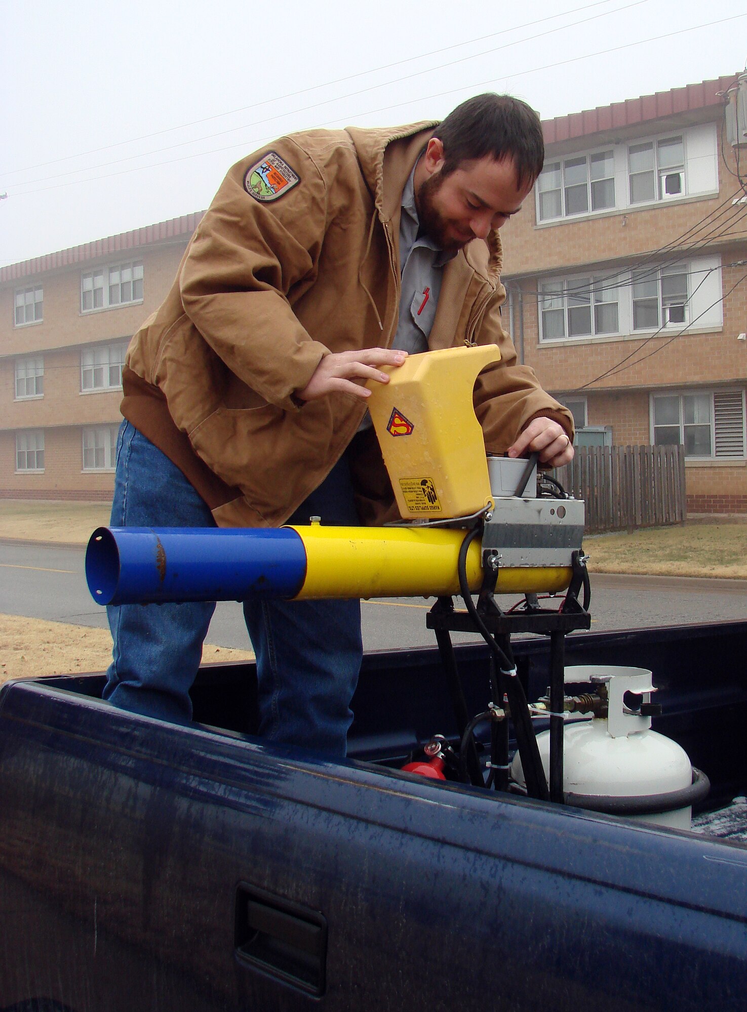 Mr. Aaron Betts readies a propane cannon, used to keep wildlife away from base, on Dec. 18 (U.S. Air Force photo by 2nd Lt. Lynn Aird)