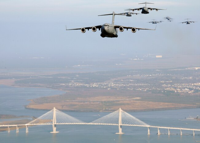 Charleston AFB C-17s fly over the Arthur Ravenel bridge, as part of a 13-aircraft formation training exercise Dec. 18. The formation flight demonstrated the U.S. Air Force's strategic capability. The training mission included airdrops over North Auxiliary Airfield in Orangeburg, S.C., and aerial refueling training. (U.S. Air Force photo/Airman 1st Class Katie Gieratz)

