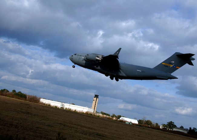 The first C-17 lands on the Charleston AFB flightline after completing the 13-aircraft formation training exercise Dec 18. The formation flight demonstrated the U.S. Air Force's strategic capability. The training mission also included aerial refueling. (U.S. Air Force photo/Senior Airman Timothy Taylor)
