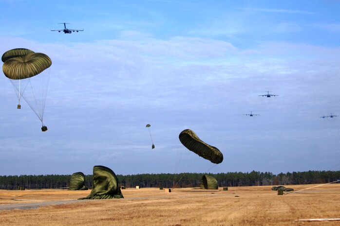 Charleston AFB C-17s perform an airdrop training mission as part of a 13-aircraft formation training exercise at North Auxiliary Field, Orangeburg, S.C., Dec 18. The formation flight demonstrated the U.S. Air Force's strategic capability. The training mission also included aerial refueling. (U.S. Air Force photo/Senior Airman Timothy Taylor)