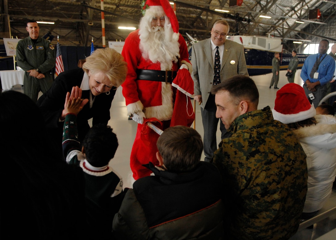 Mary Peters, Secretary of Transportation, and Santa Claus talk to military members and their children on Dec. 18. Ms. Peters and Santa were on base signing documents allowing Santa to fly in special military airspace called "Santa Skylanes" in order to deliver gifts to good boys and girls Christmas Eve. (U.S. Air Force photo by Senior Airman Melissa Stonecipher)