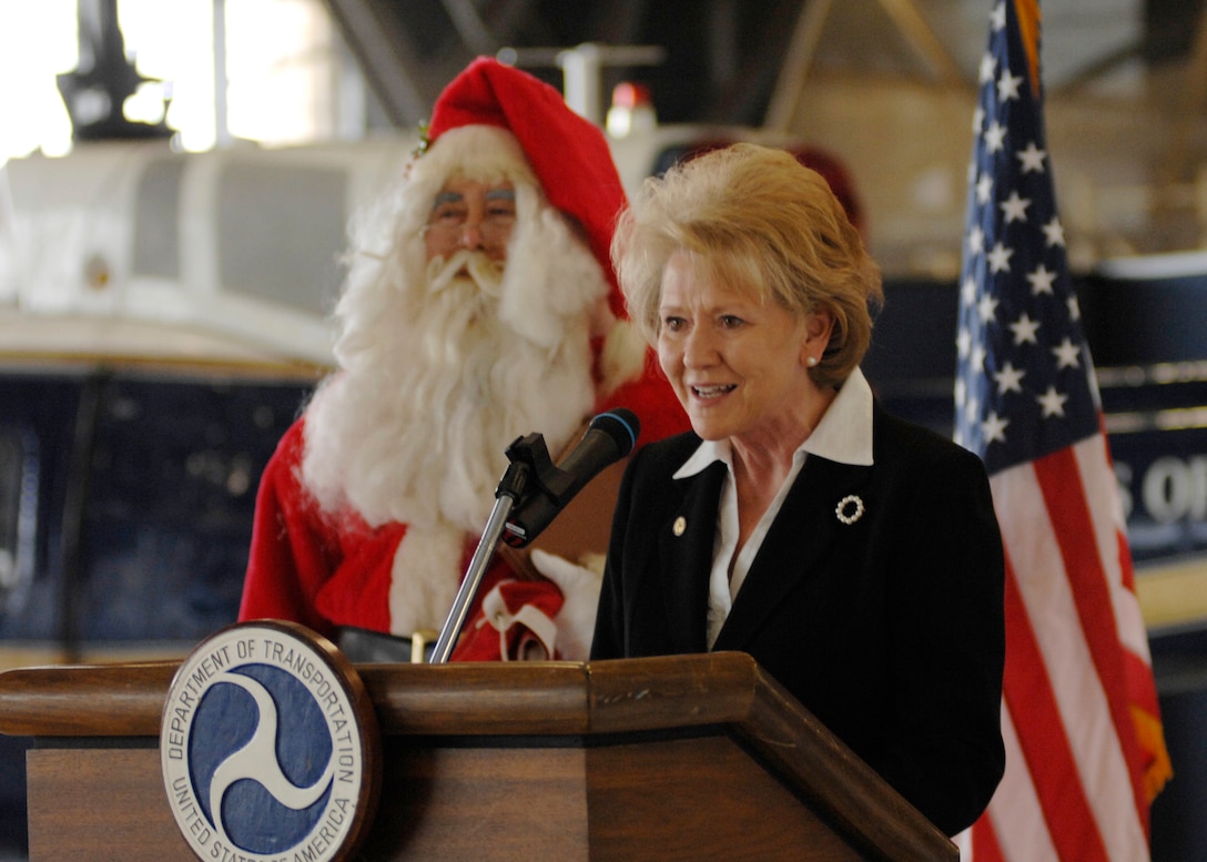 Mary Peters, Secretary of Transportation, speaks to Andrews Airmen and families Dec. 18 in Hanger 1 on Andrews Air Force Base, Md.  She spoke about Santa Claus and how the military is going to help Santa complete his Christmas mission. The military is opening up airspace called "Santa Skylanes" so Santa can deliver gifts to good boys and girls in time for Christmas. (U.S. Air Force photo by Senior Airman Melissa Stonecipher)
