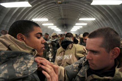Basic trainees inspect each others body armor during five-day deployment exercise called the Basic Expeditionary Airman Skills and Training, or BEAST, which kicked off Dec. 15 at Lackland Air Force Base, Texas. (U.S. Air Force photo/Staff Sgt. Desiree N. Palacios)