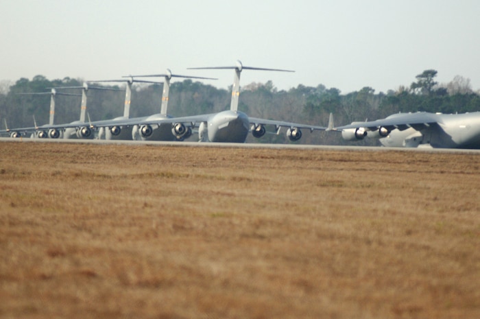 Charleston AFB C-17's taxi on the flight line prior to being cleared for takeoff as part of a 13 aircraft formation training mission here Dec. 18. The formation flight demonstrated the U.S. Air Force's strategic capability. The training mission included airdrops over North Auxiliary Airfield in Orangeburg, S.C., and aerial refueling training. (U.S. Air Force photo/Staff Sgt. Marie Cassetty)