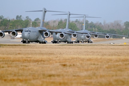 Charleston AFB C-17's taxi on the flight line prior to being cleared for takeoff as part of a 13 aircraft formation training mission here Dec. 18. The formation flight demonstrated the U.S. Air Force's strategic capability. The training mission included airdrops over North Auxiliary Airfield in Orangeburg, S.C., and aerial refueling training. (U.S. Air Force photo/Staff Sgt. Marie Cassetty)