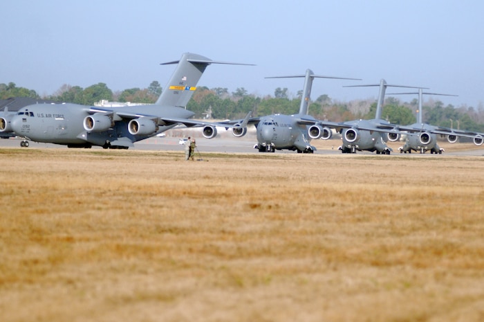 Charleston AFB C-17's taxi on the flight line prior to being cleared for takeoff as part of a 13 aircraft formation training mission here Dec. 18. The formation flight demonstrated the U.S. Air Force's strategic capability. The training mission included airdrops over North Auxiliary Airfield in Orangeburg, S.C., and aerial refueling training. (U.S. Air Force photo/Staff Sgt. Marie Cassetty)